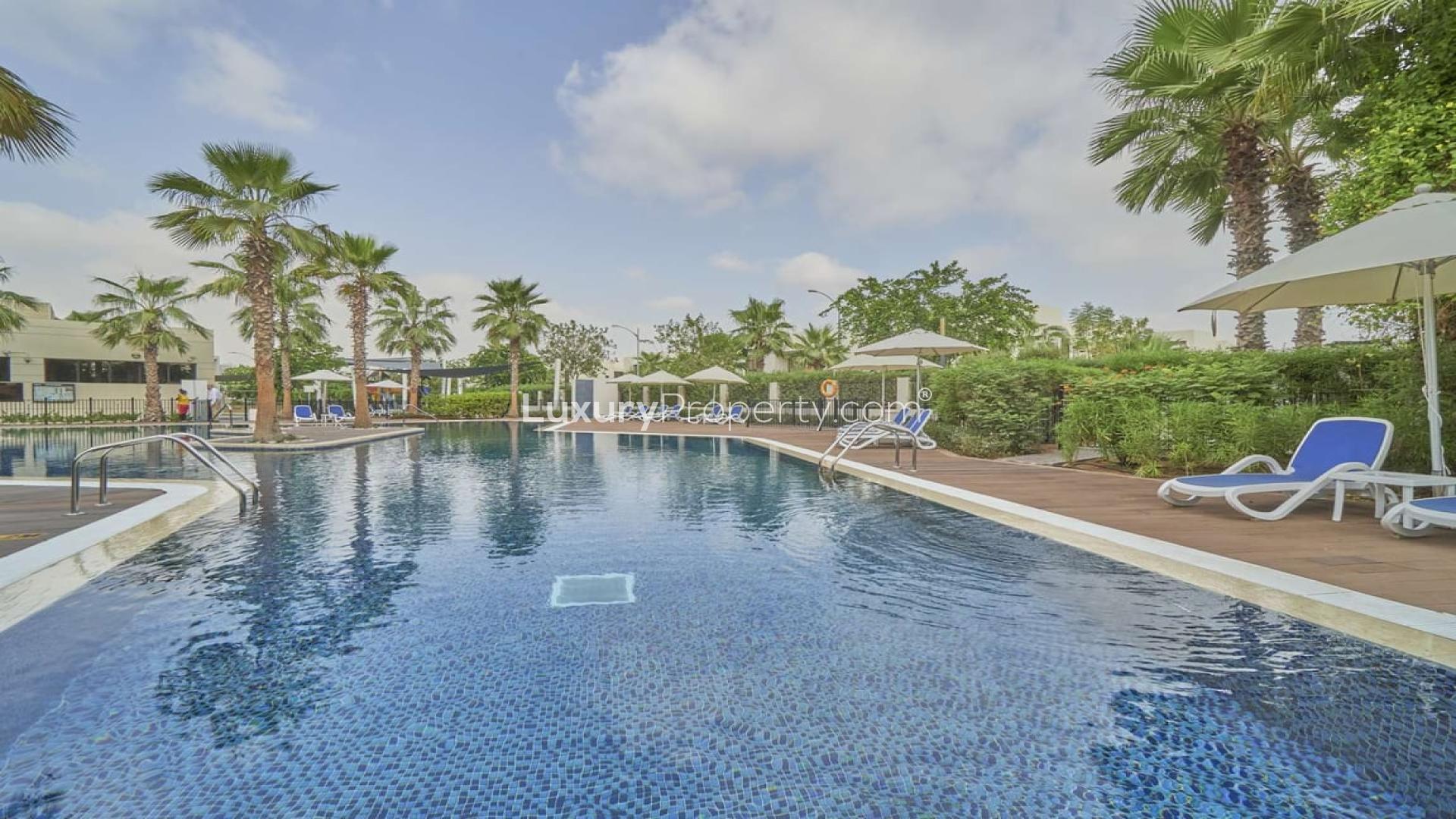 Modern living room in 5-bedroom villa, Damac Hills, featuring elegant decor and garden view