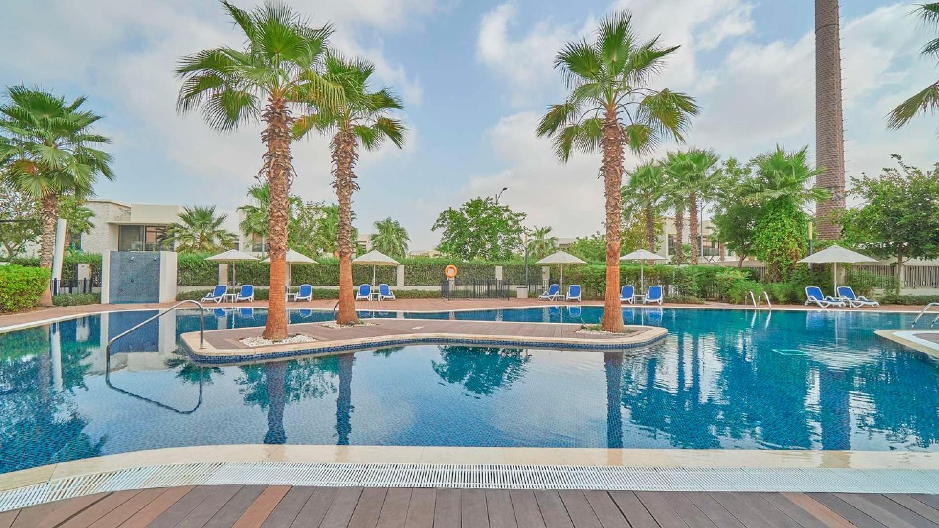 Modern 5-bedroom villa exterior with driveway in Damac Hills, Silver Springs community