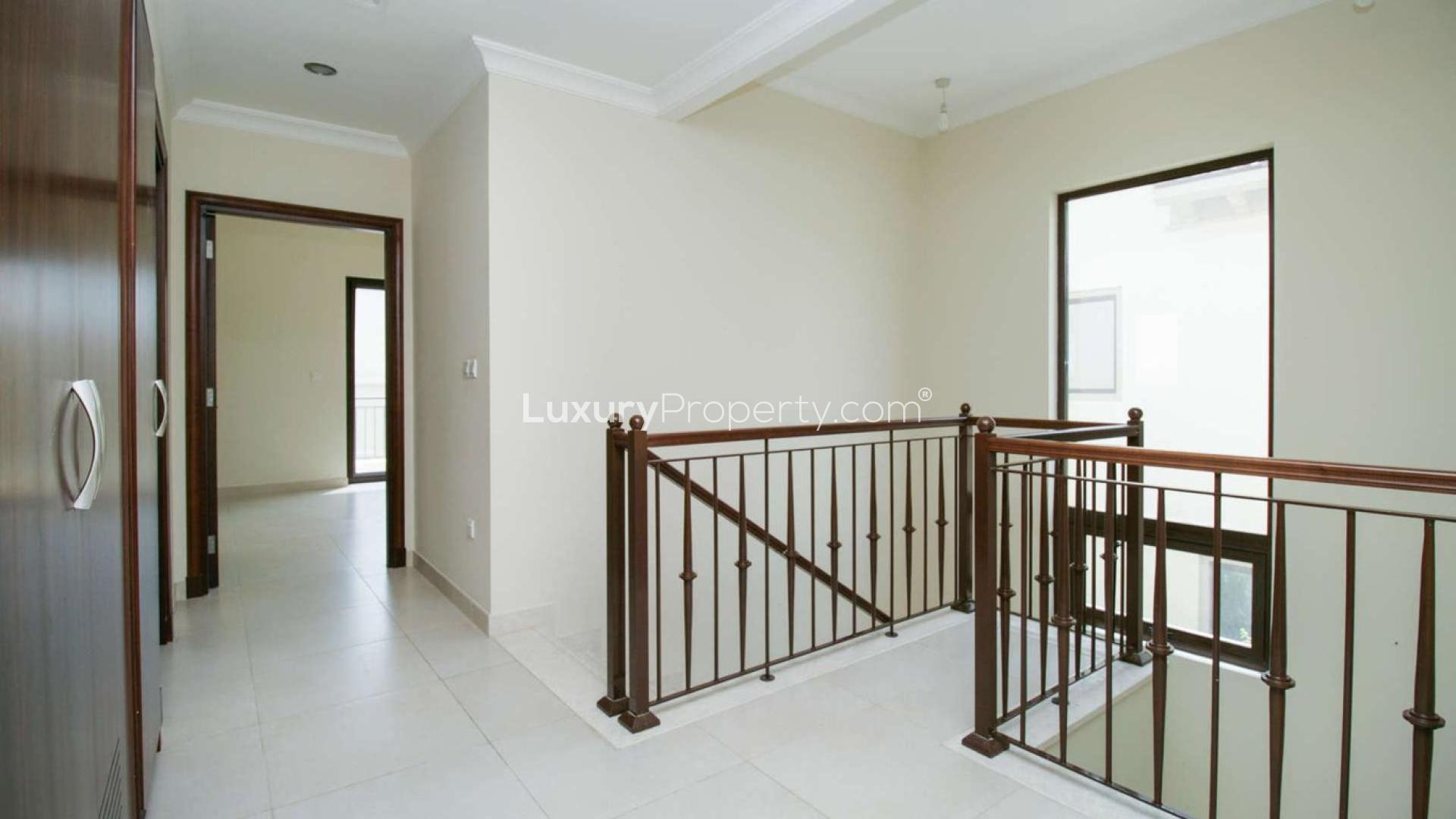 Upstairs hallway with railing in five-bedroom Palma villa, Arabian Ranches 2, for rent
