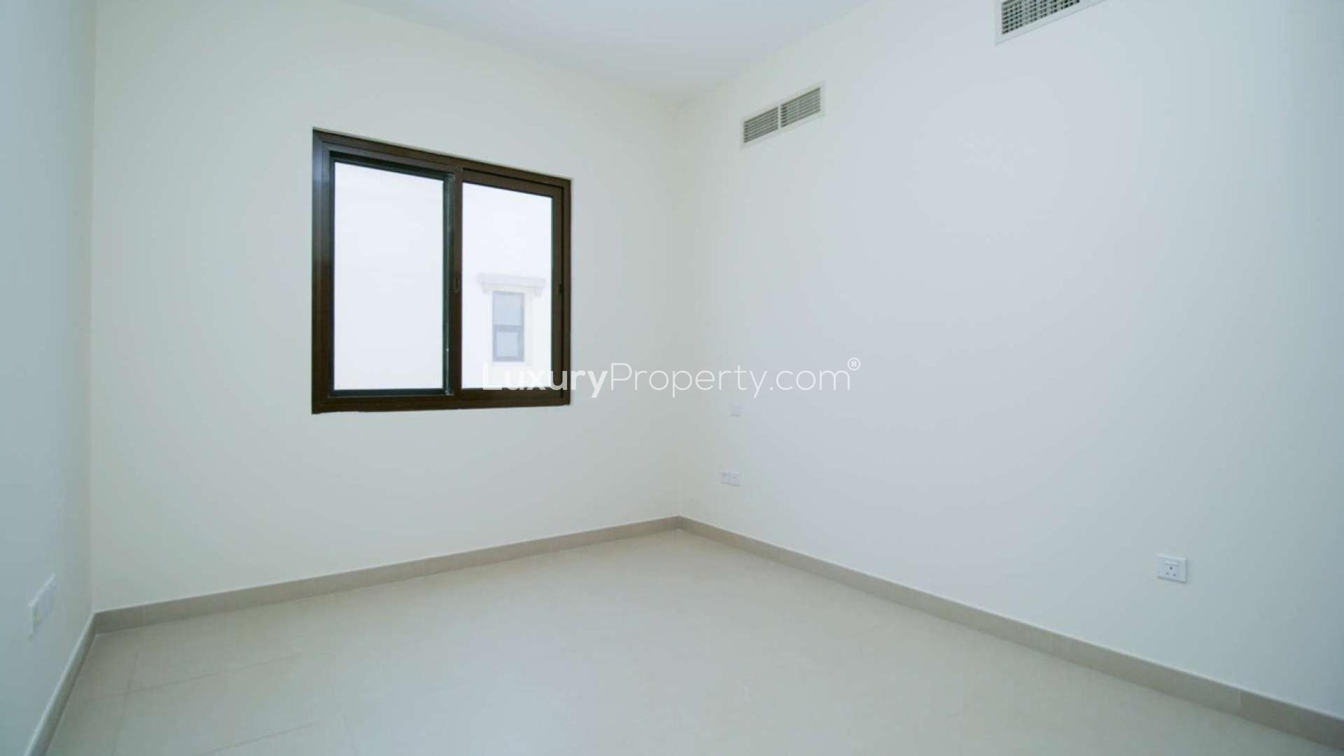 "Spacious 5-bedroom villa exterior with garden in Lila, Arabian Ranches 2 for rent.",Empty bedroom interior in spacious Type 5 villa, Lila, Arabian Ranches 2 for rent