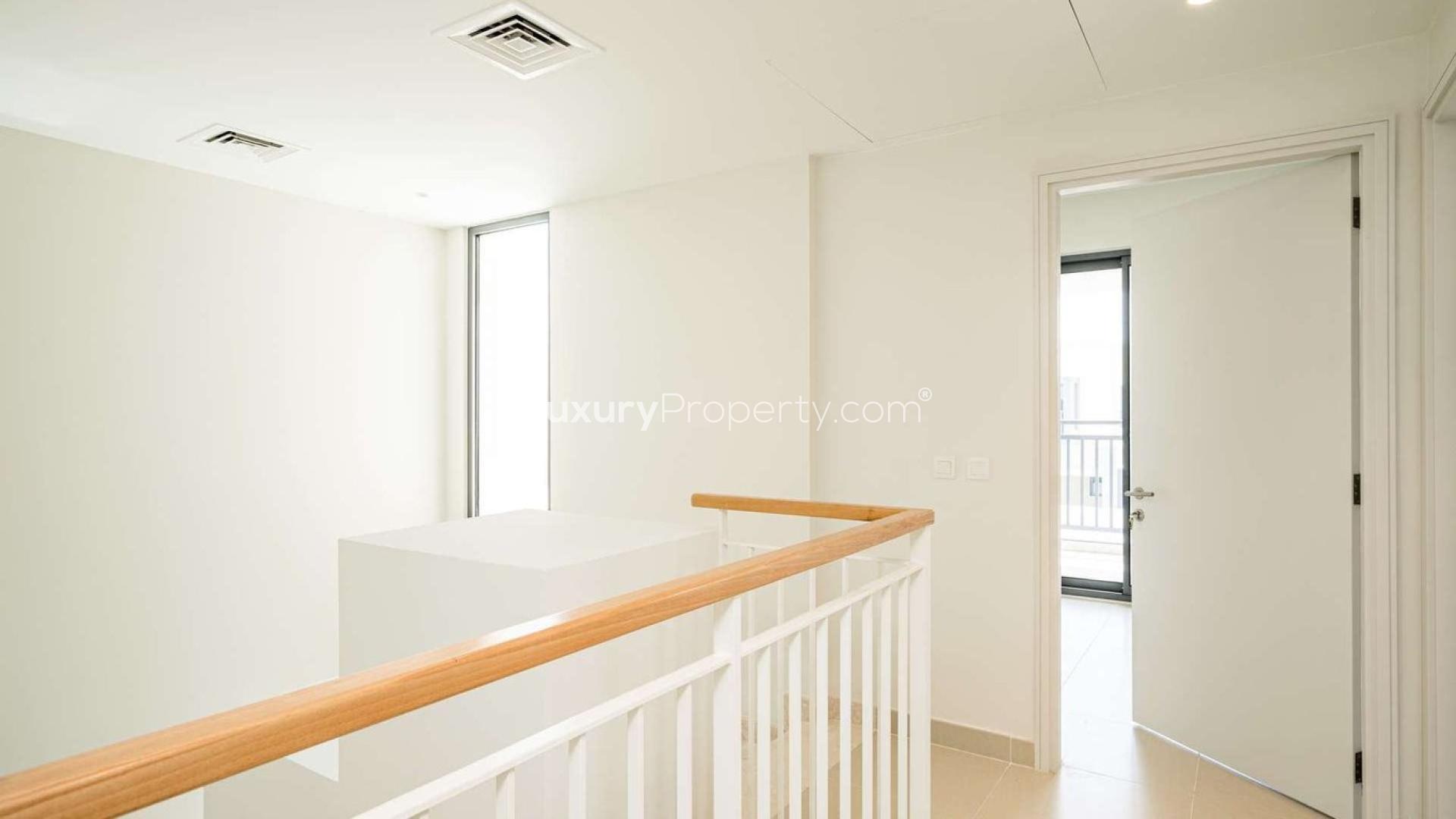 Modern living room in 5-bedroom villa, Maple, Dubai Hills Estate, with stylish decor and staircase