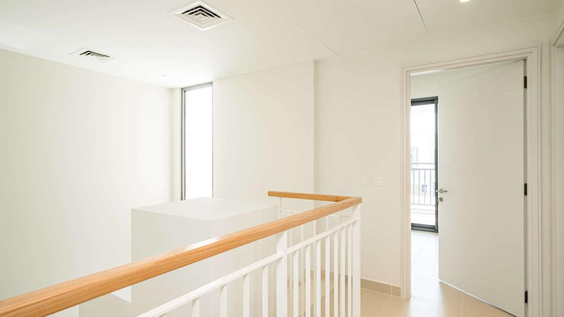 Modern living room in 5-bedroom villa, Maple, Dubai Hills Estate, with stylish decor and staircase