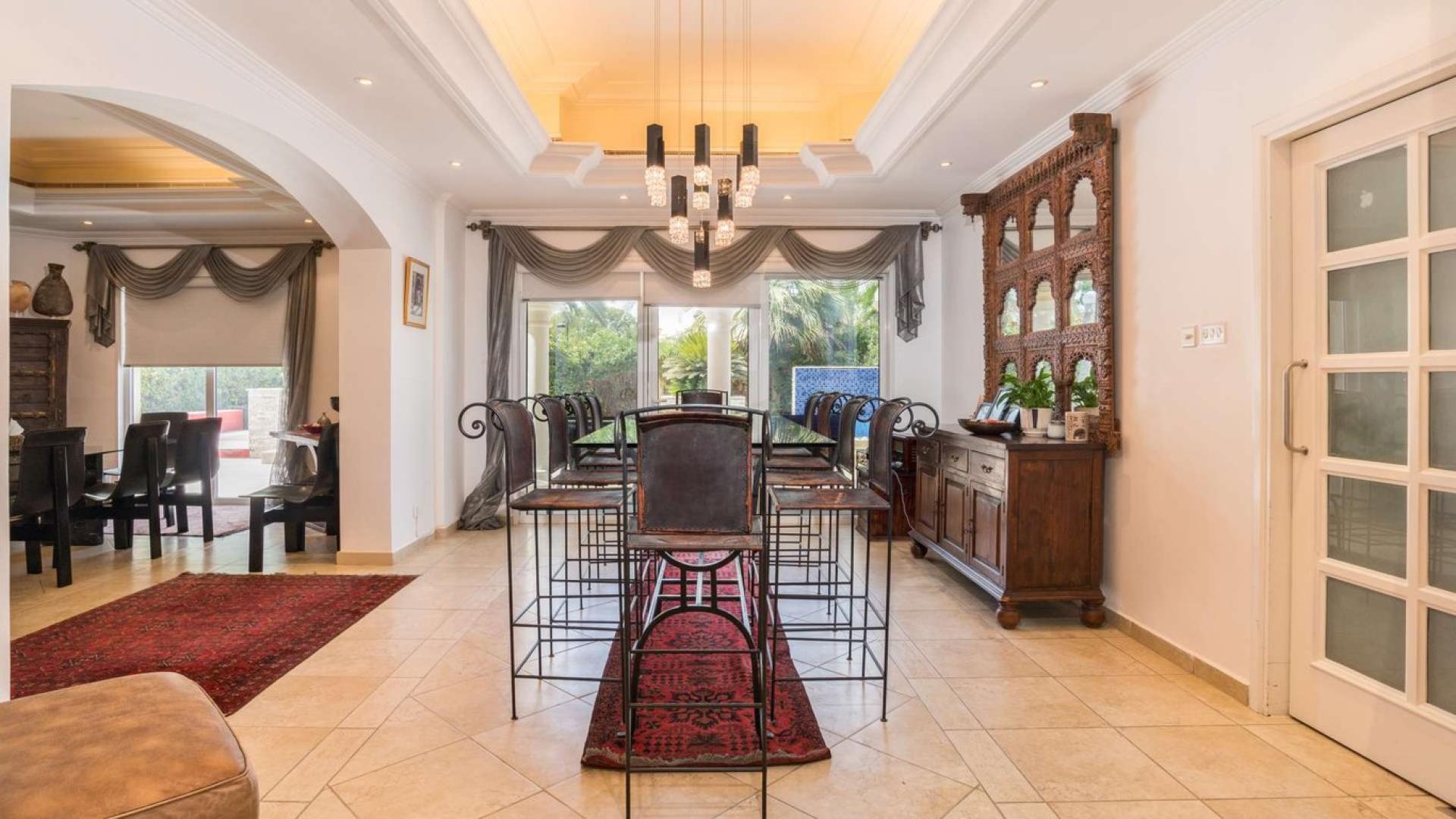 Elegant dining area in 5-bedroom villa, Green Community West, featuring stylish decor and natural light