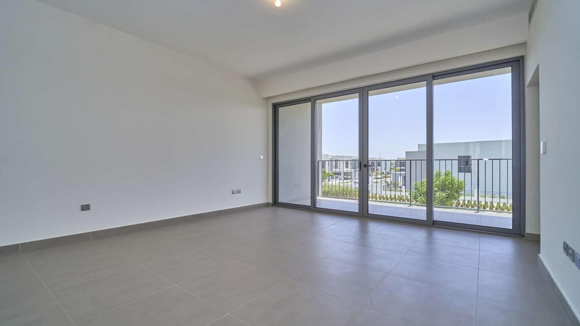 Spacious living room with large windows in Dubai Hills Estate villa for rent