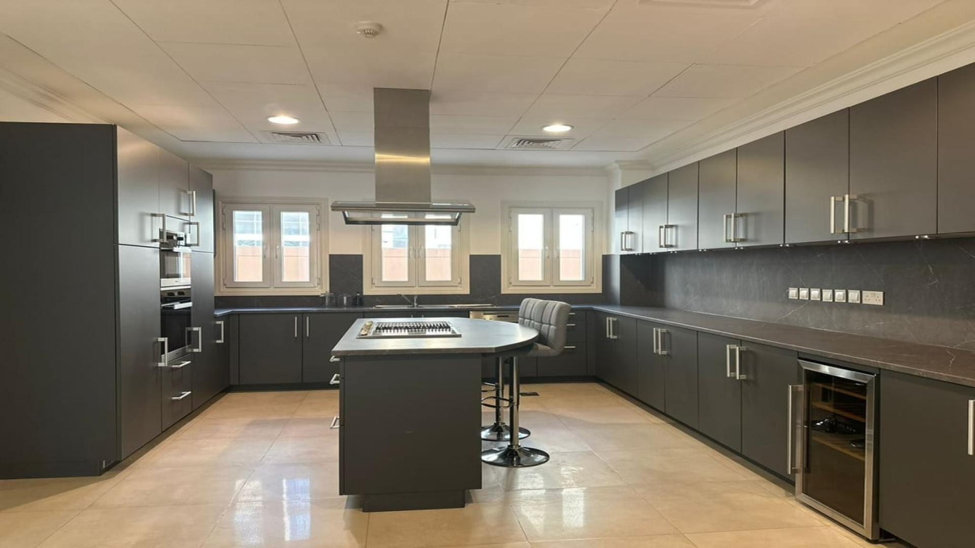 Modern kitchen in Sienna Lakes Villa, Jumeirah Golf Estates, with sleek cabinetry and central island