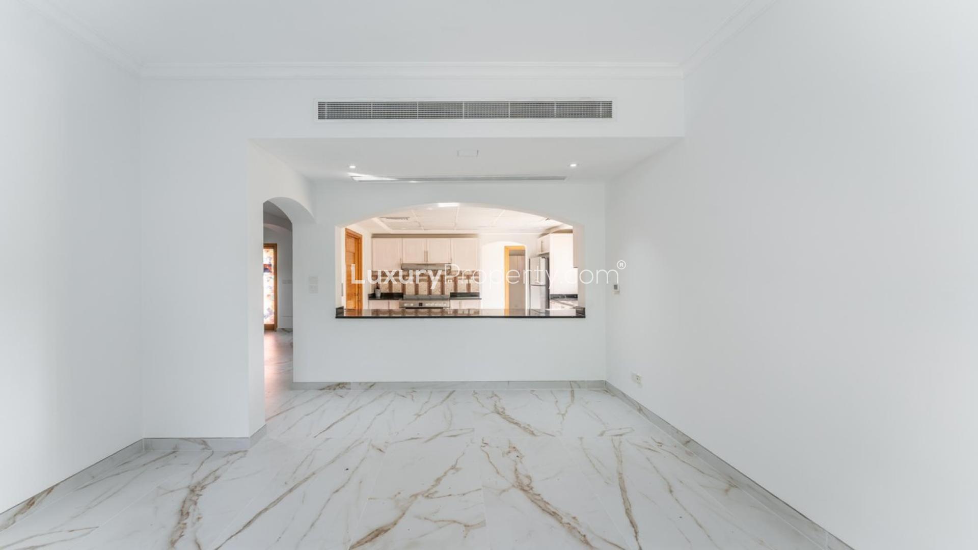 Luxurious living room in 5-bedroom Meadows villa, featuring elegant furniture and garden views