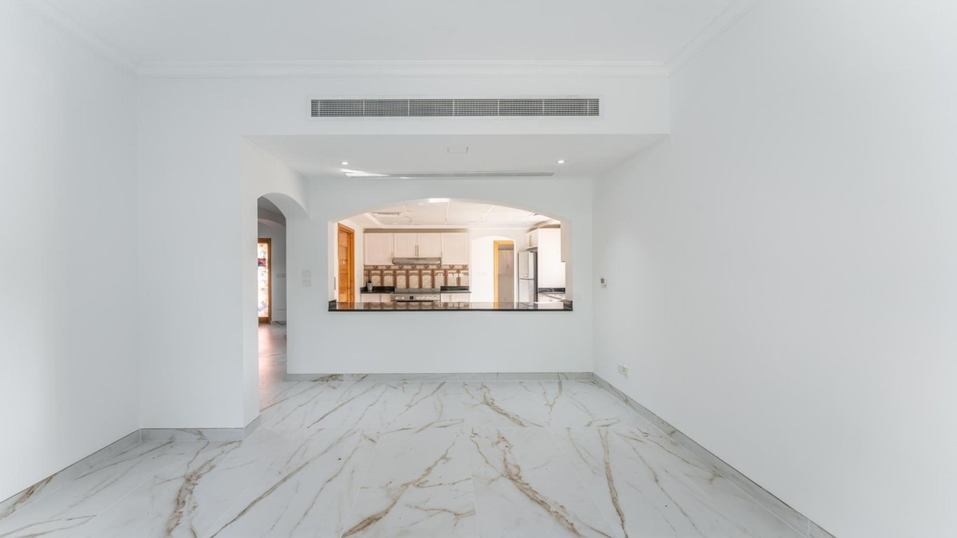 Luxurious living room in 5-bedroom Meadows villa, featuring elegant furniture and garden views