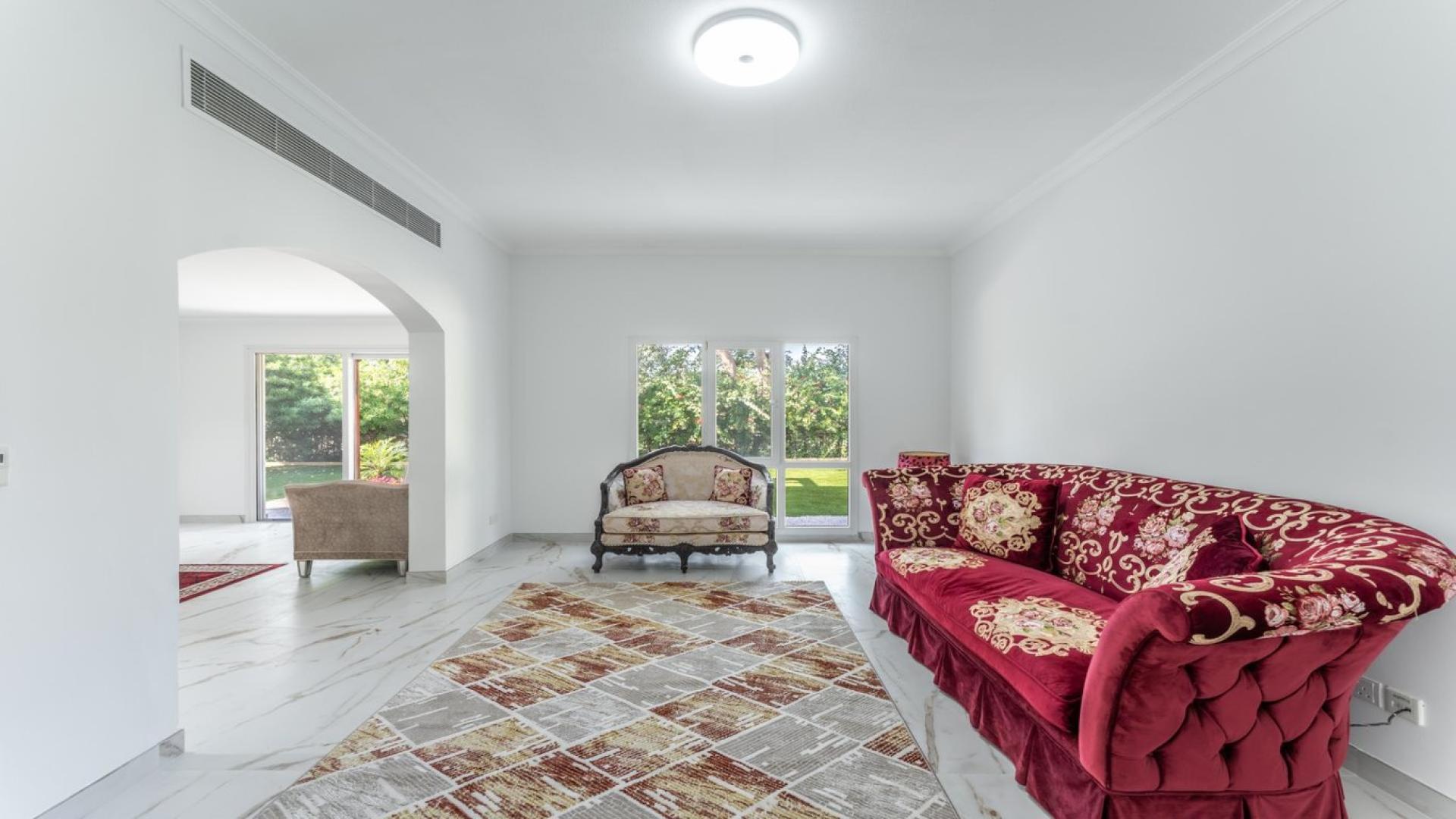 Luxurious living room in 5-bedroom villa for rent, Meadows 6, with garden view