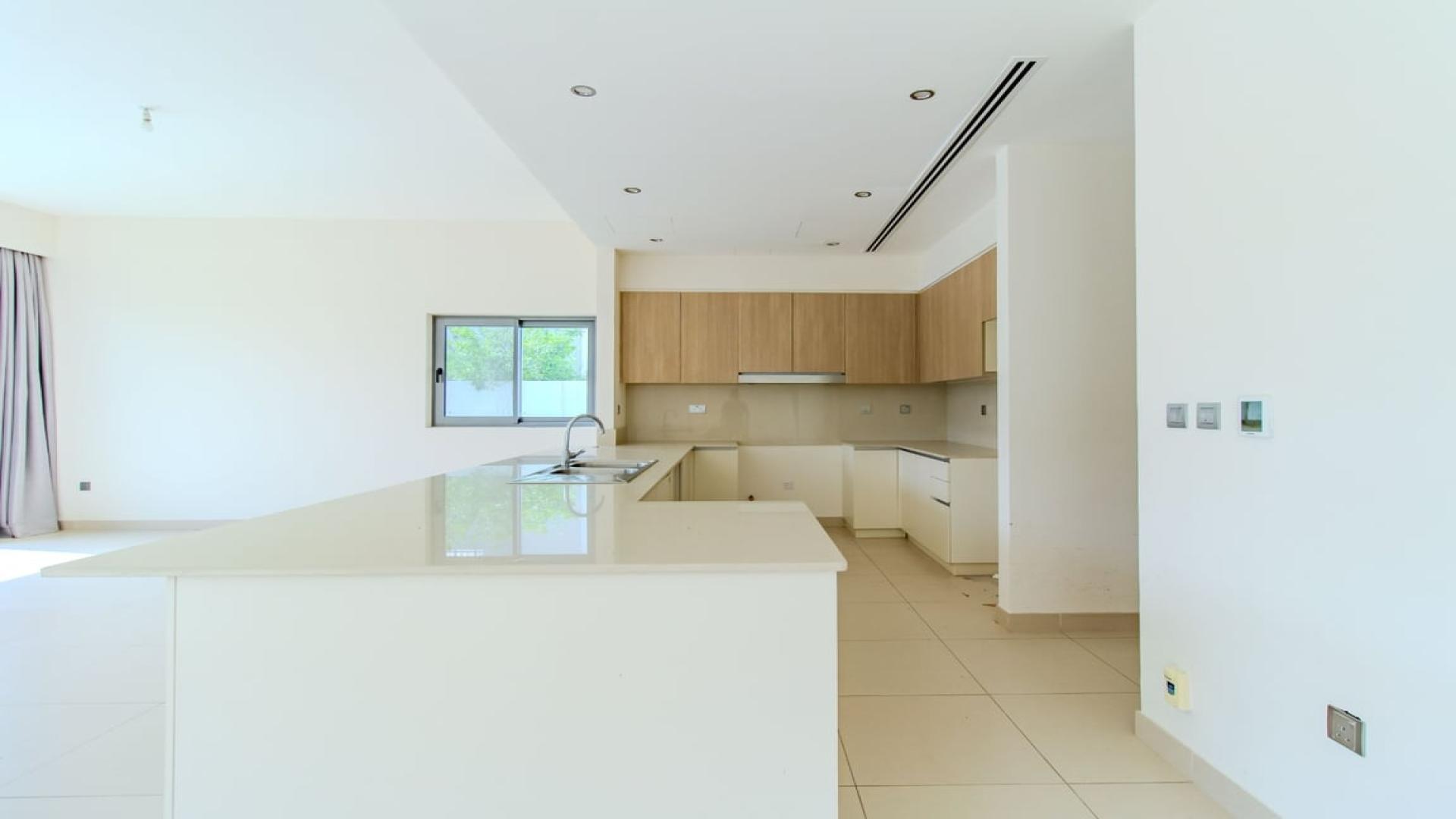 Modern open-plan kitchen and living area in Sidra Villas, Dubai Hills Estate