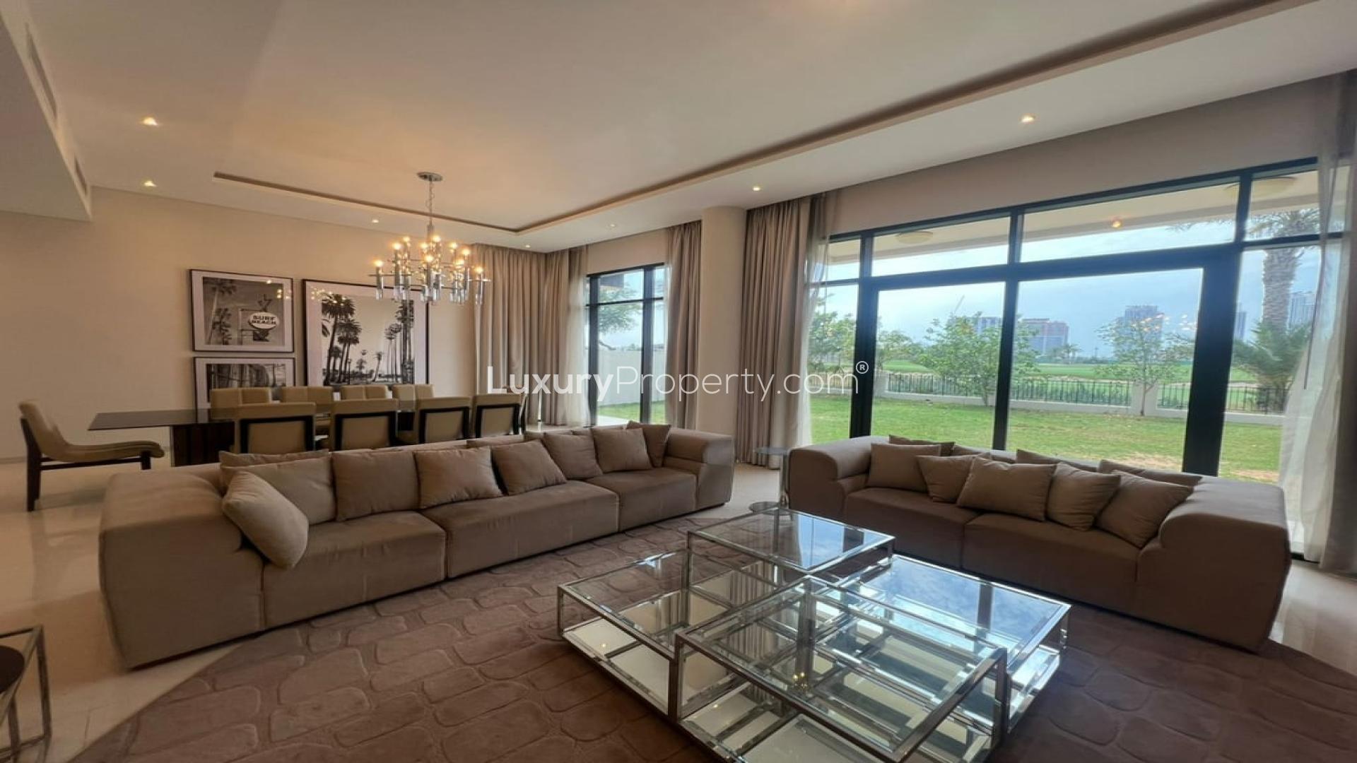 Luxurious furnished villa living room with garden view in Damac Hills, The Turf