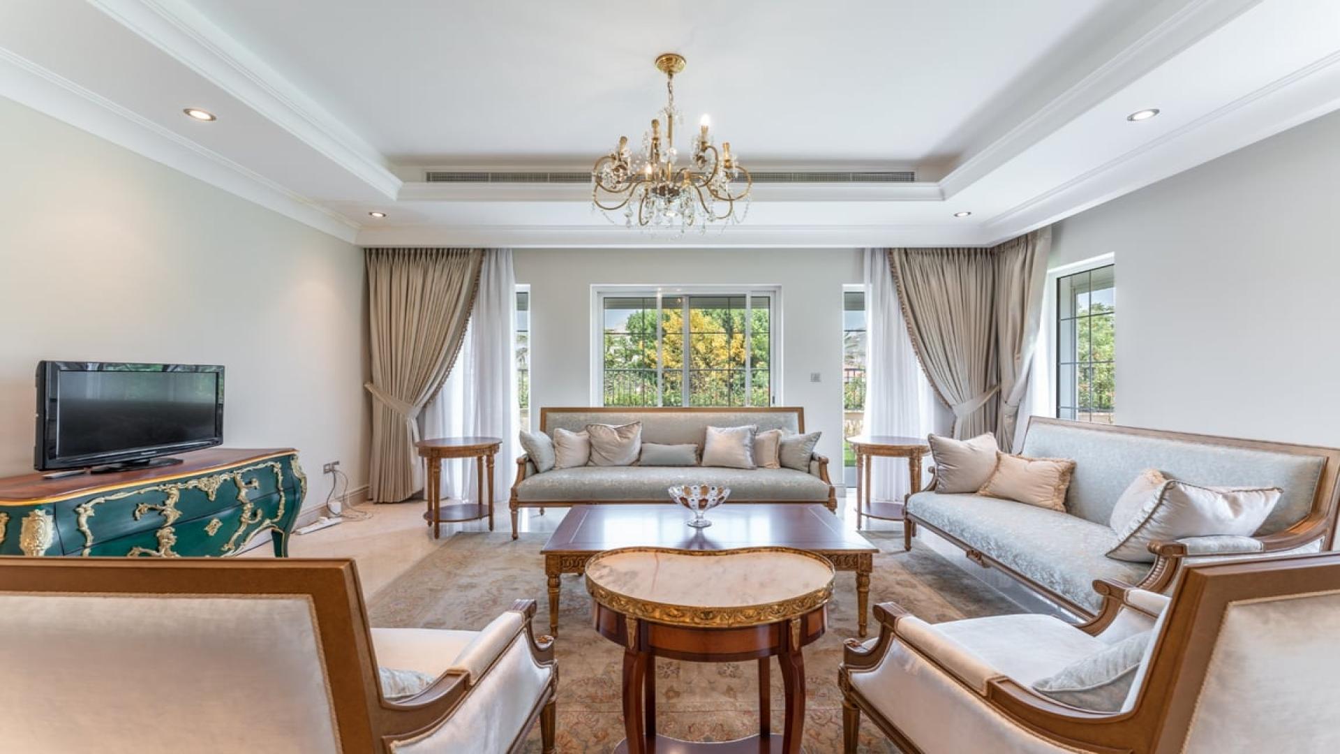 Elegant living room in La Avenida villa, Arabian Ranches, featuring classic decor and natural light