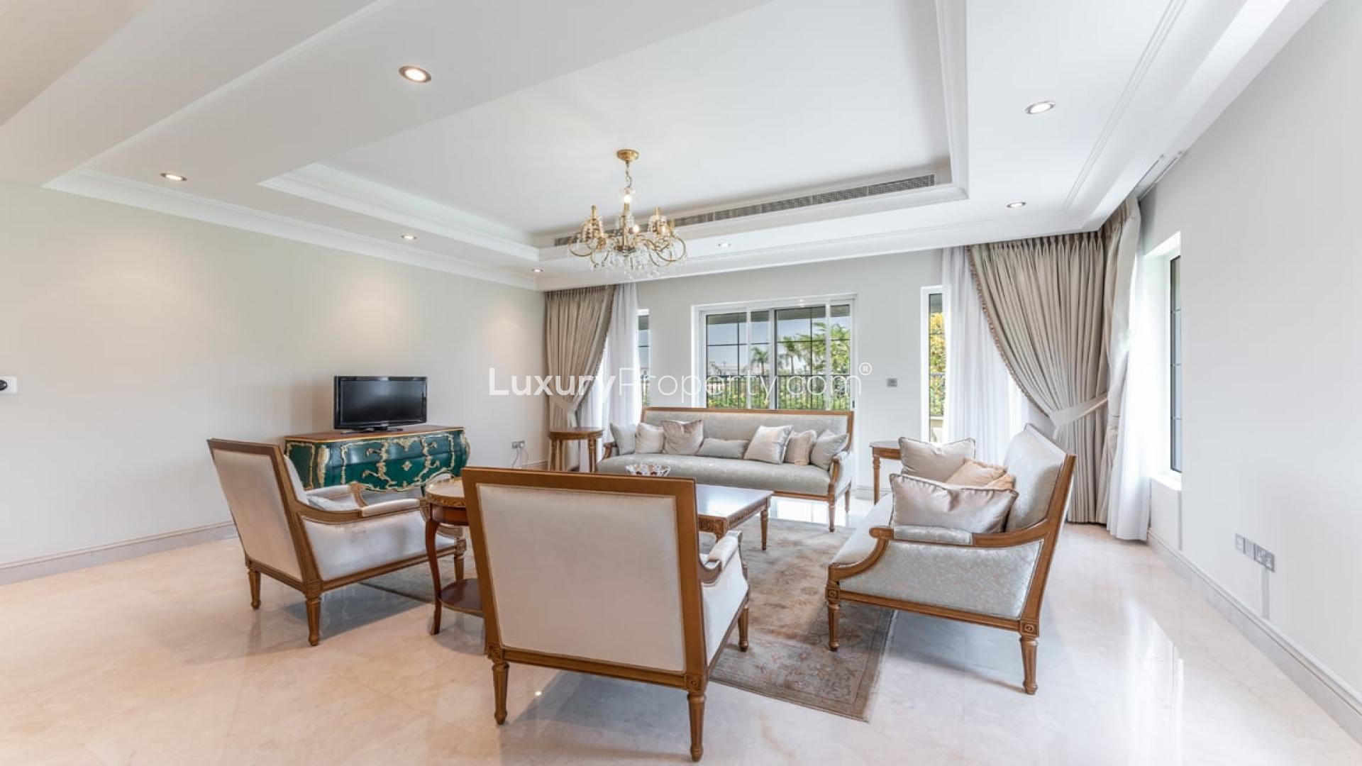 Elegant living room in La Avenida villa, Arabian Ranches, featuring classic furnishings and chandeliers