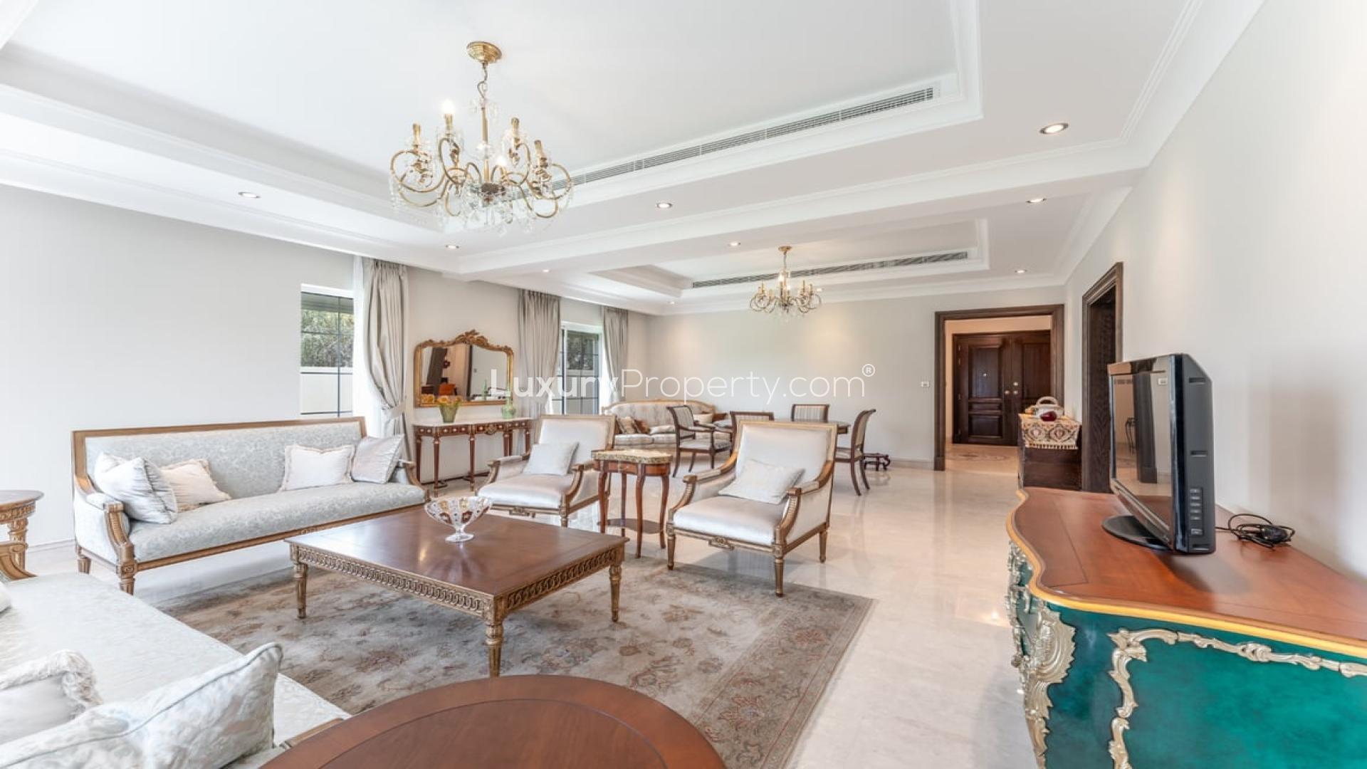 Luxurious living room in La Avenida villa, Arabian Ranches, featuring elegant decor and chandeliers