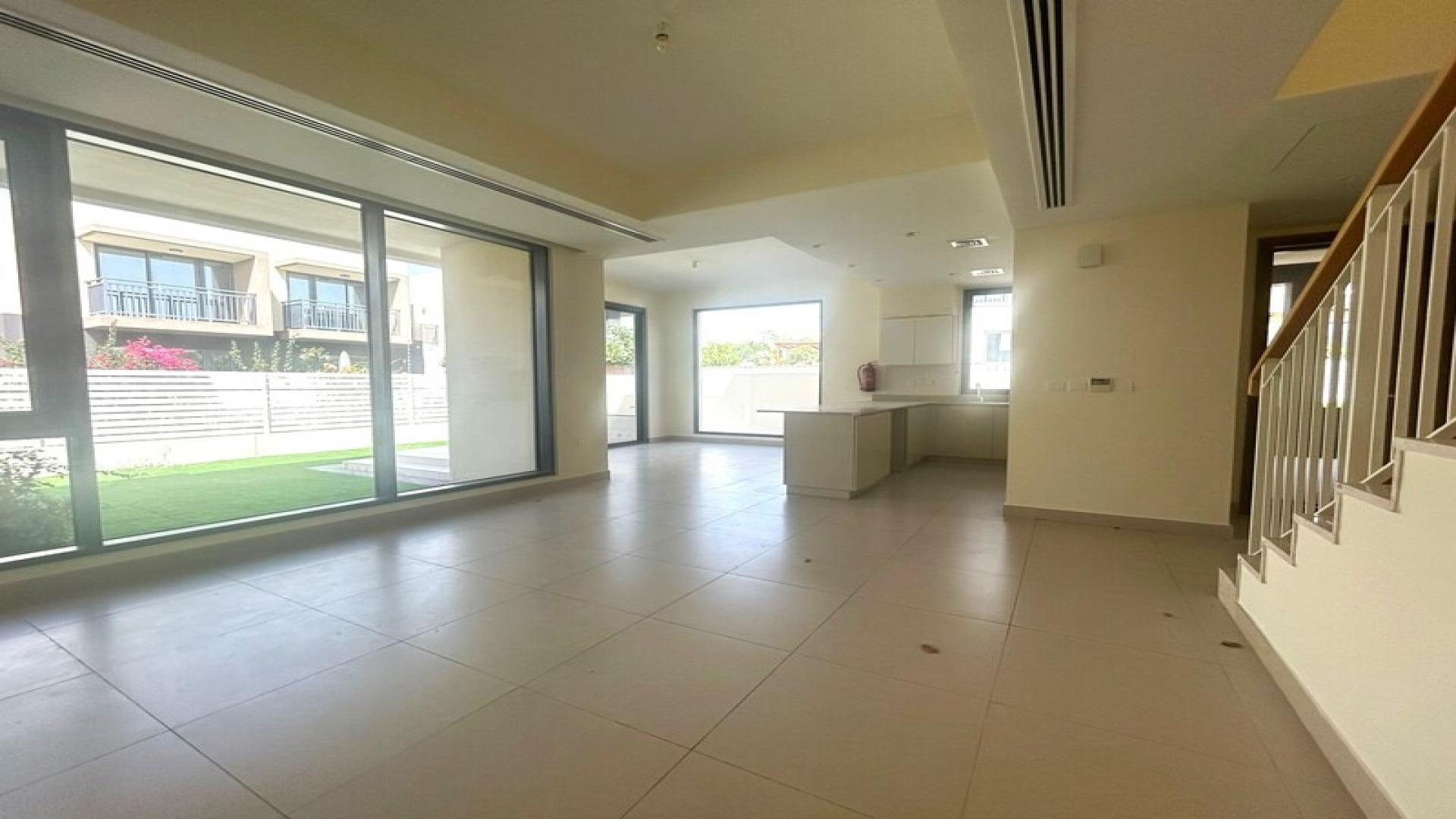 Villa backyard with green lawn and patio in Maple at Dubai Hills Estate