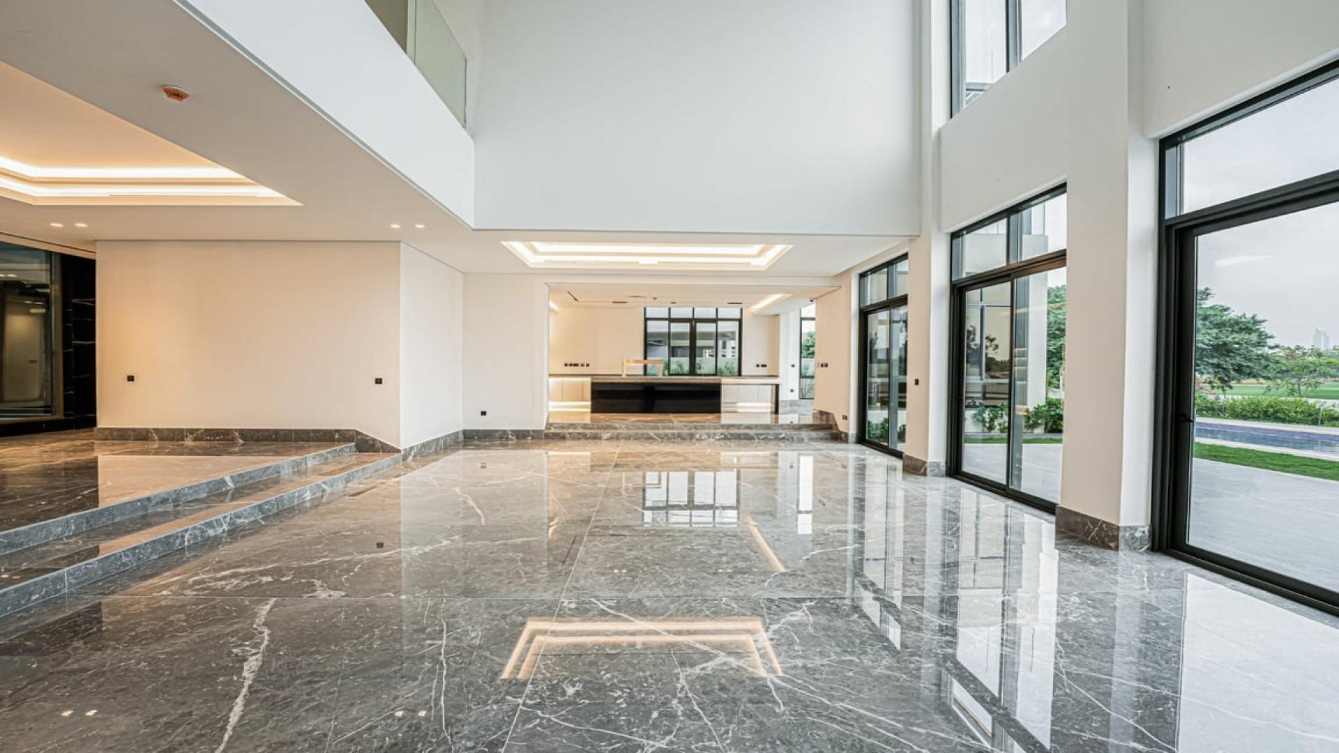 Luxurious open-plan interior of Jumeirah Golf Estates villa with marble floors and large windows