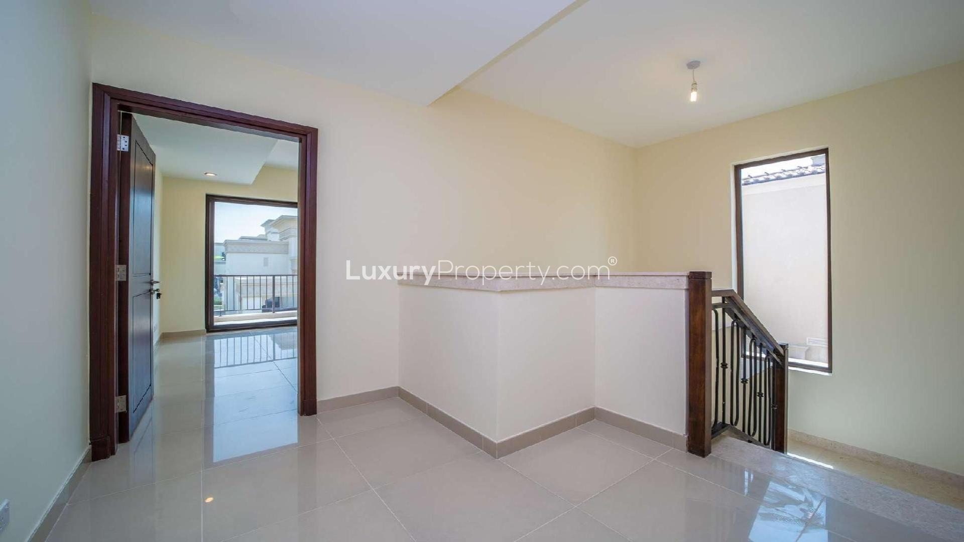 "Modern kitchen with granite countertops in 5-bedroom villa, Samara, Arabian Ranches 2 for rent.",Modern villa interior hallway in Samara, Arabian Ranches 2, featuring natural light and stairs