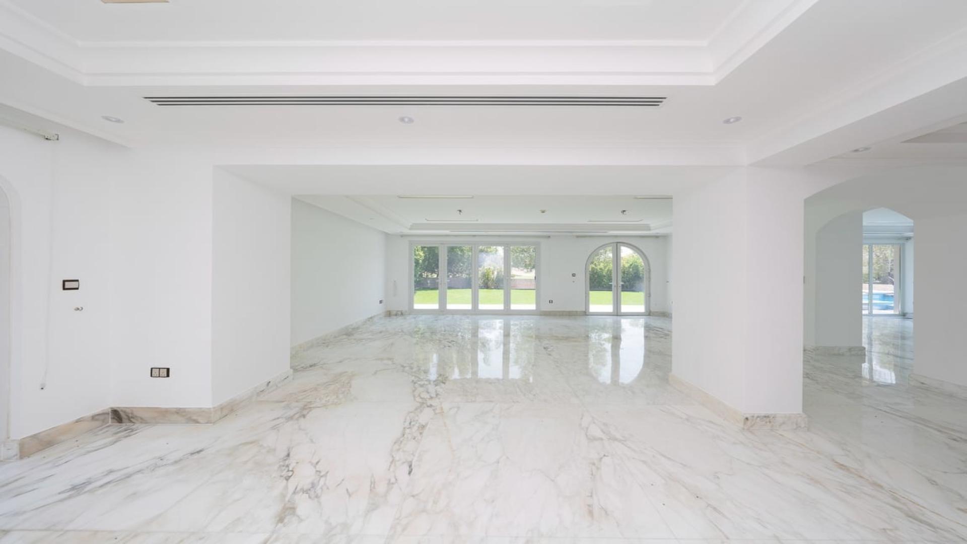 Spacious marble-floored living area in luxury Jumeirah Golf Estates villa for rent