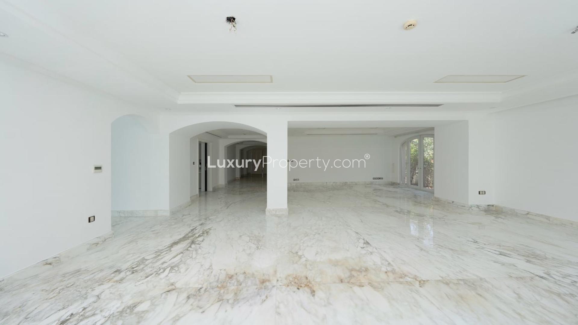 Luxurious villa interior with marble flooring and pool view in Jumeirah Golf Estates