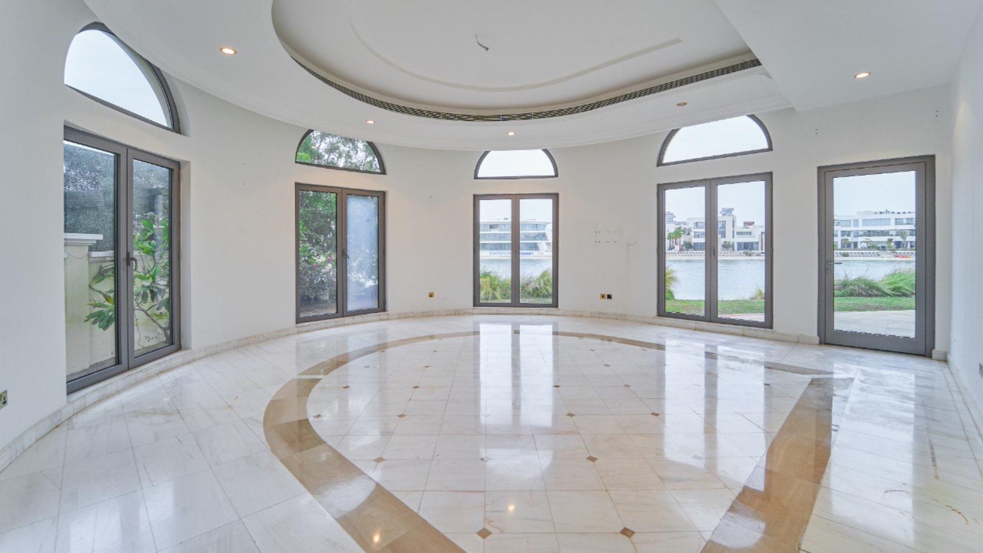 Luxurious villa interior with large windows and waterfront view on Palm Jumeirah