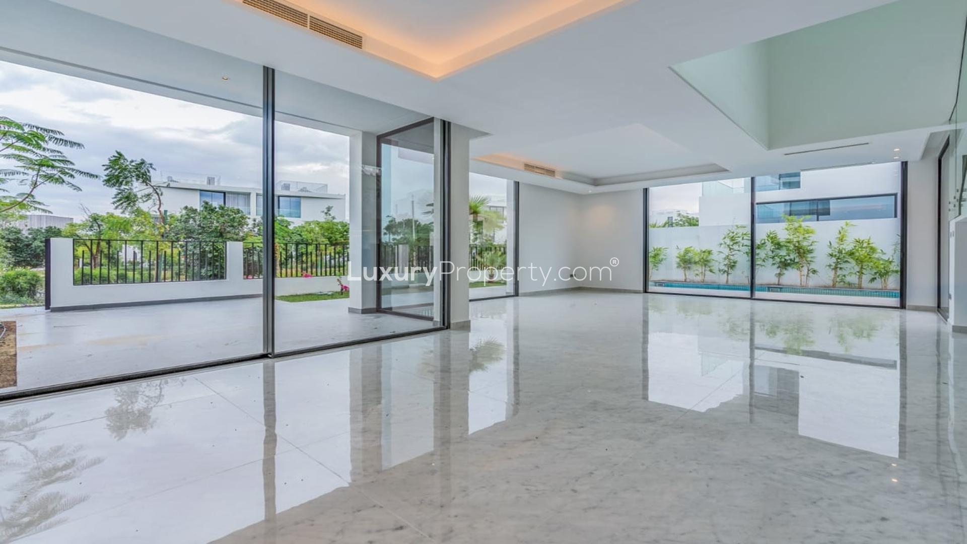 Contemporary villa exterior in Al Barari, Chorisia 2, with lush landscaping and modern design