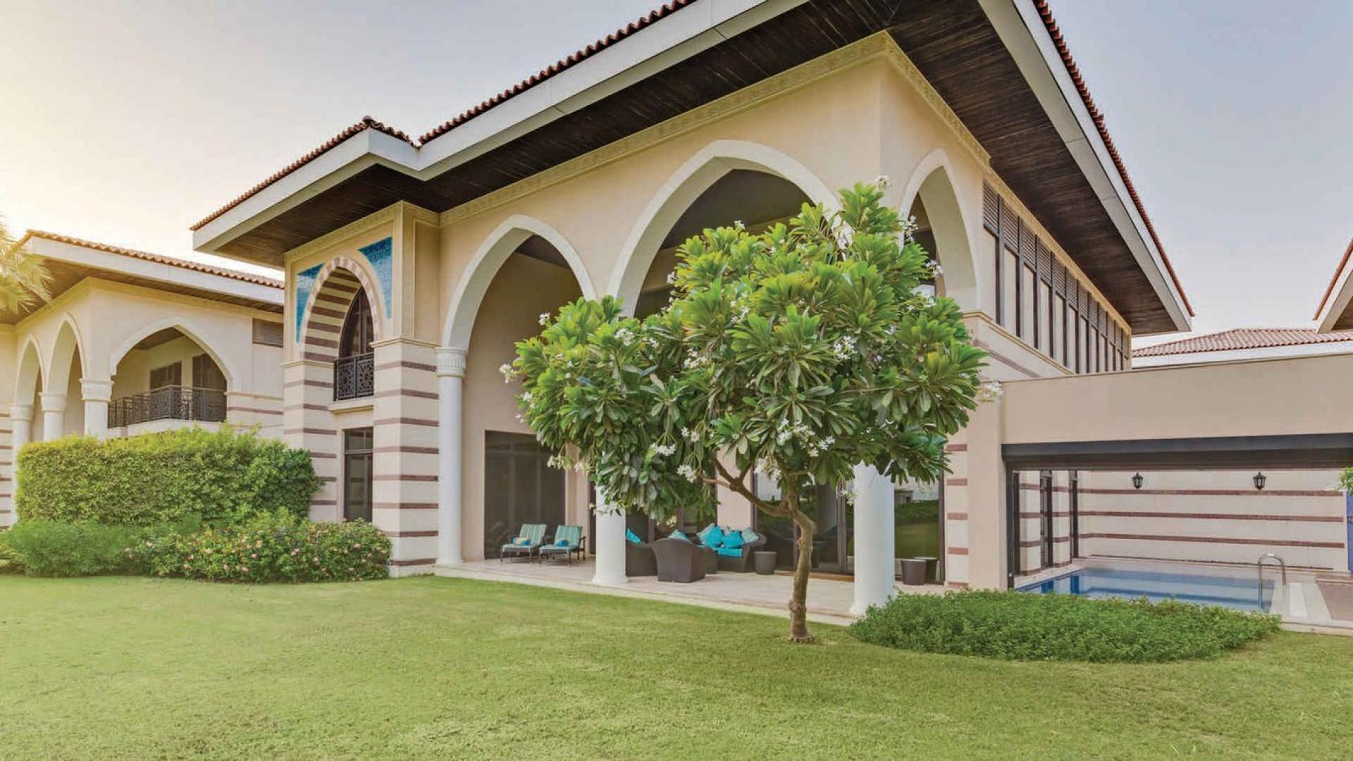 "Luxurious lagoon villa view from living room, Palm Jumeirah, The Crescent, for sale.",Four-bedroom lagoon villa with pool view on Palm Jumeirah, The Crescent, for sale