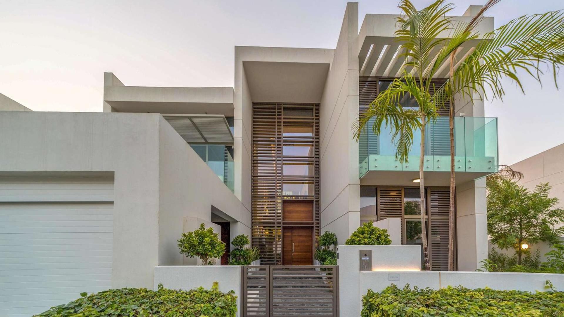 Luxurious open-plan living area in District One villa, featuring sleek marble flooring and windows