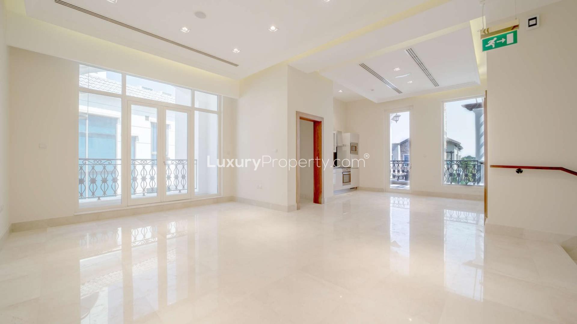 "Spacious living area in 5-bedroom villa, Jumeirah Golf Estates, Earth community, for sale.",Spacious living area with large windows in 5-bedroom villa, Jumeirah Golf Estates, Earth