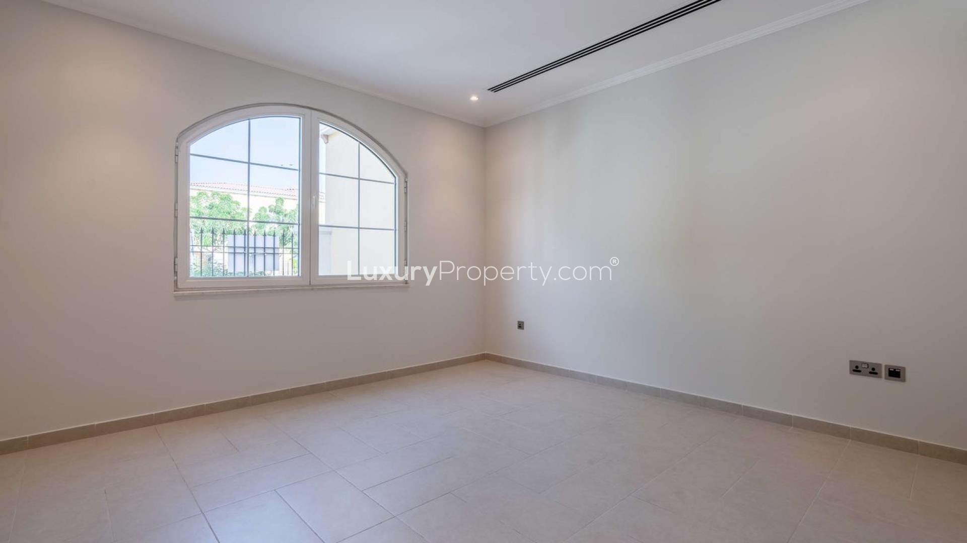 Bright empty room with arched window in five-bedroom villa, Legacy, Jumeirah Park