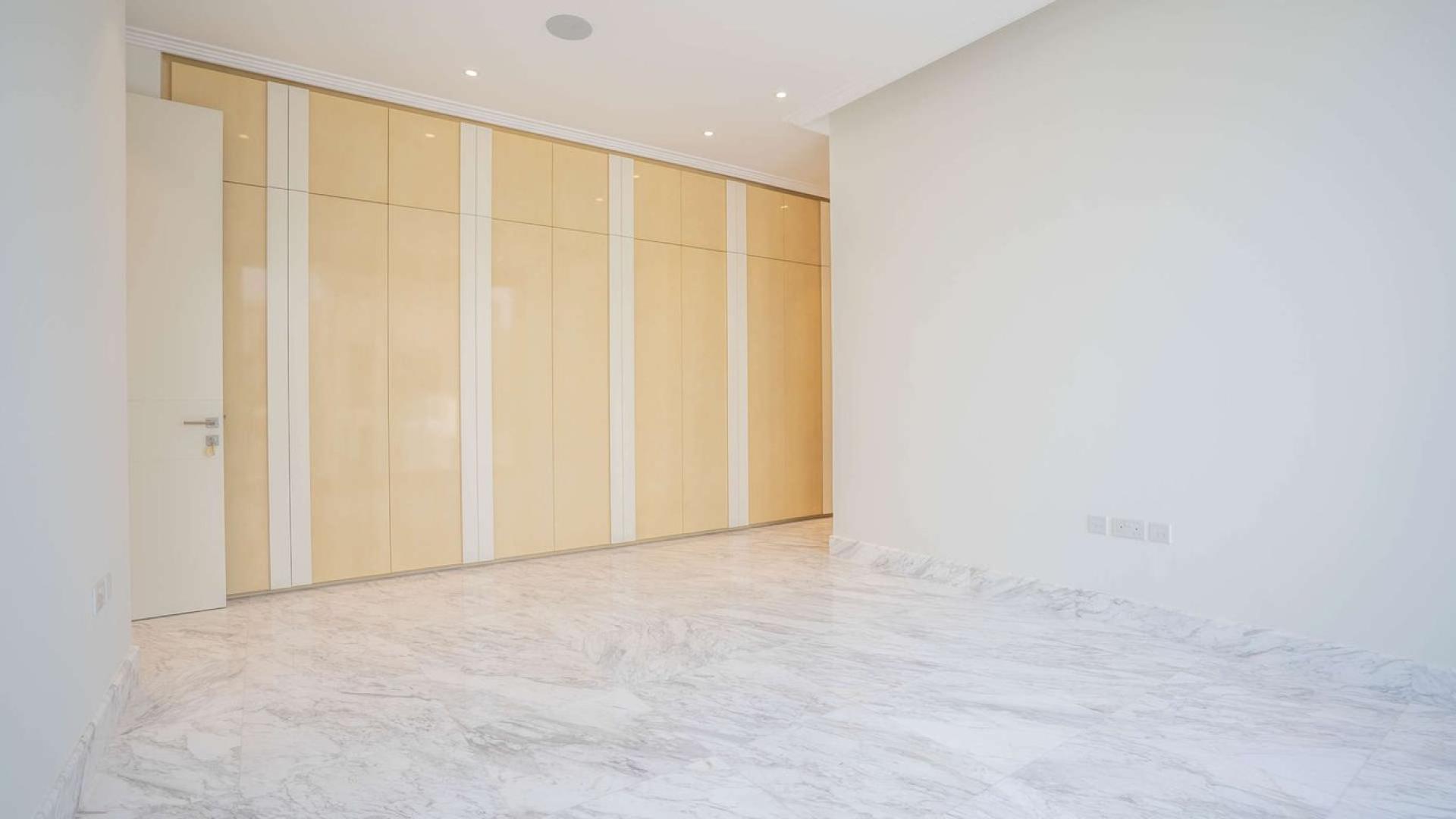 Interior view of luxury Palm Jumeirah villa kitchen with marina views and open design