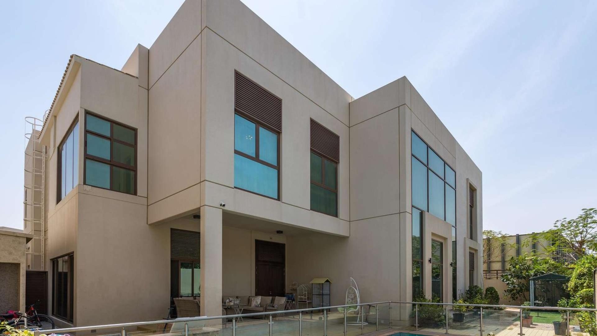 Front view of luxury villa entrance in Meydan’s Millennium Estates, lush landscaping