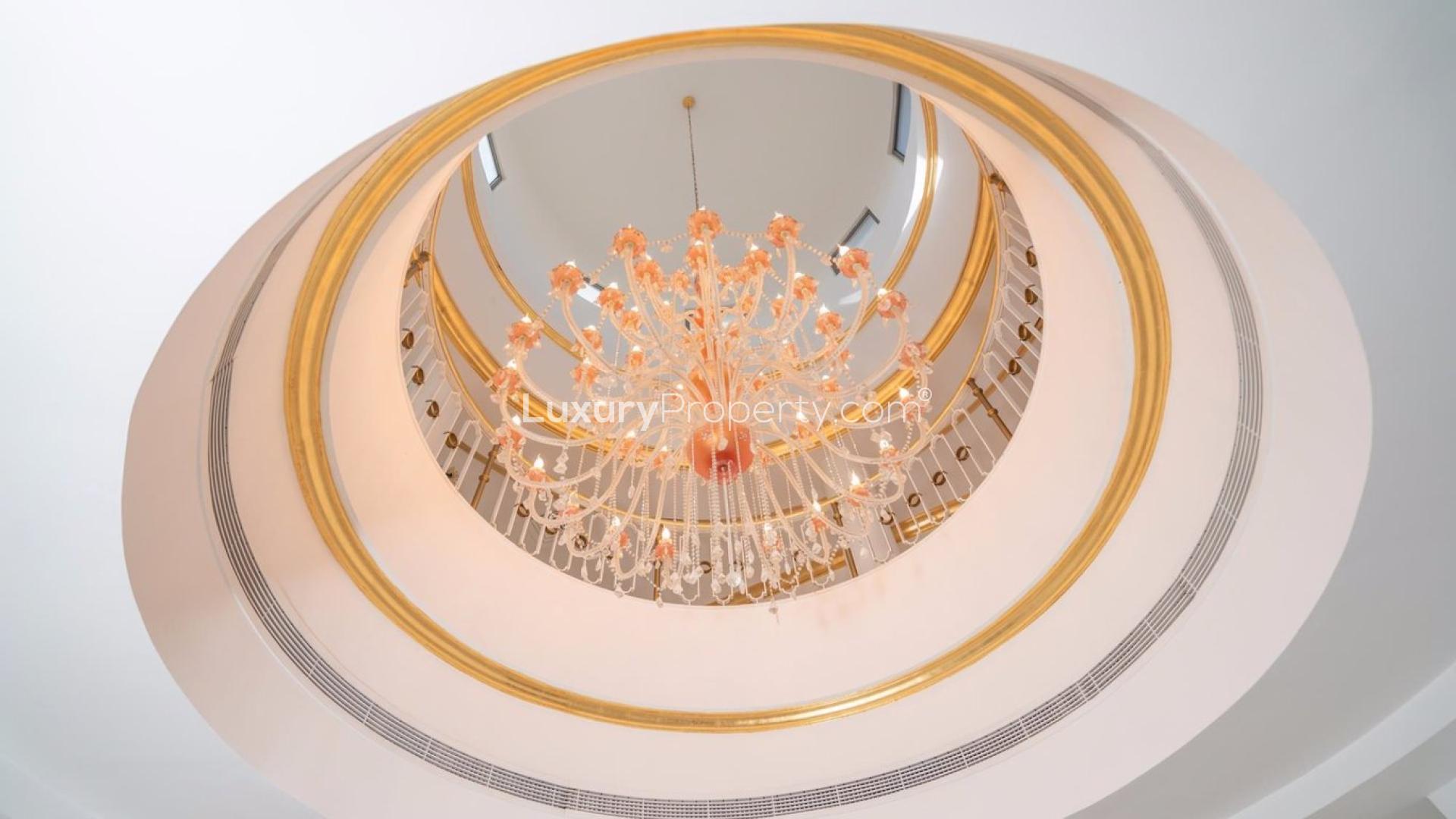 "Elegant entrance of five-bedroom villa on Palm Jumeirah, showcasing luxurious interior design.",Elegant chandelier in luxurious Palm Jumeirah Signature Villa, five-bedroom classic style residence