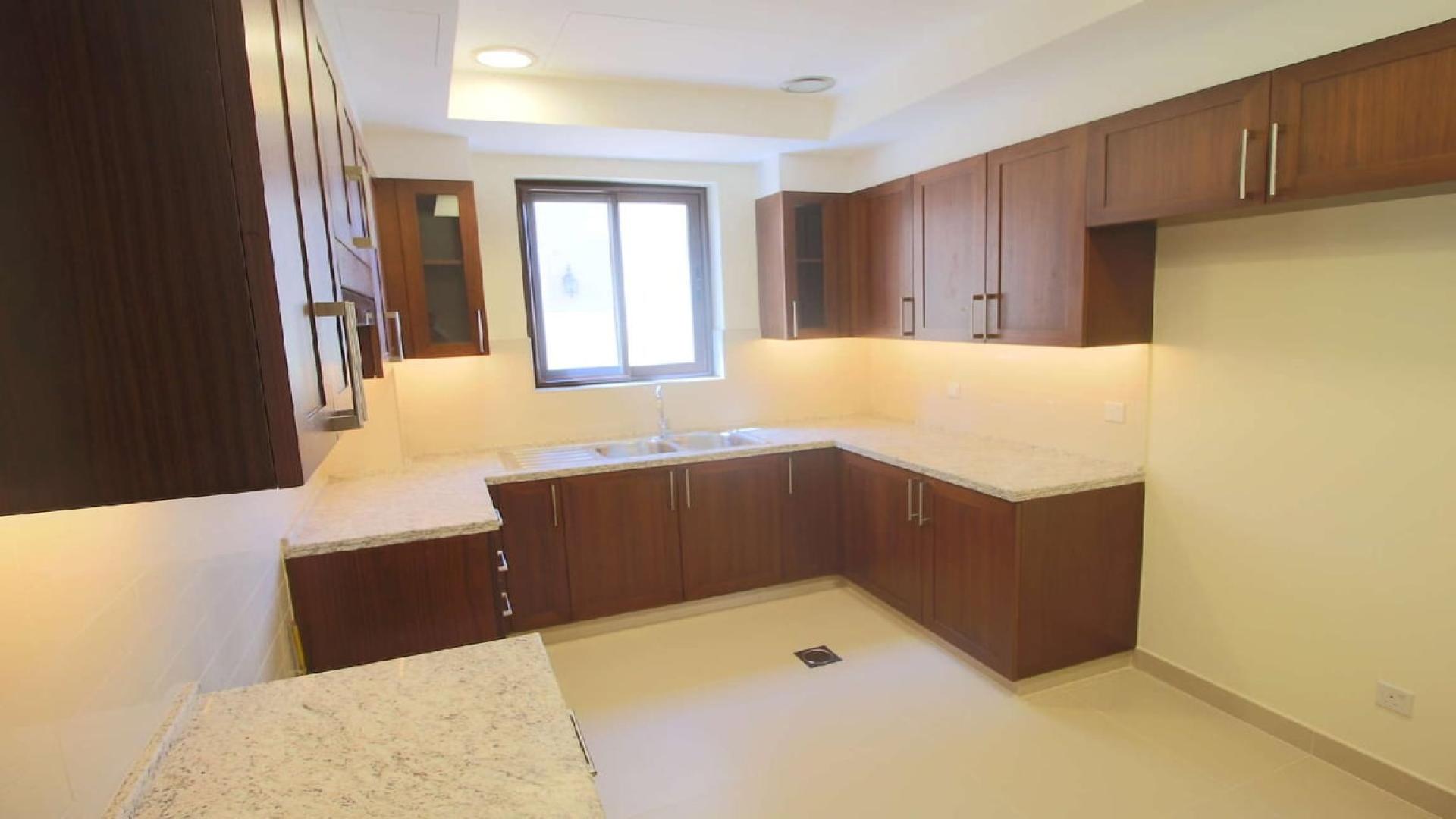 Spacious kitchen with wooden cabinets in Samara villa, Arabian Ranches 2, for sale