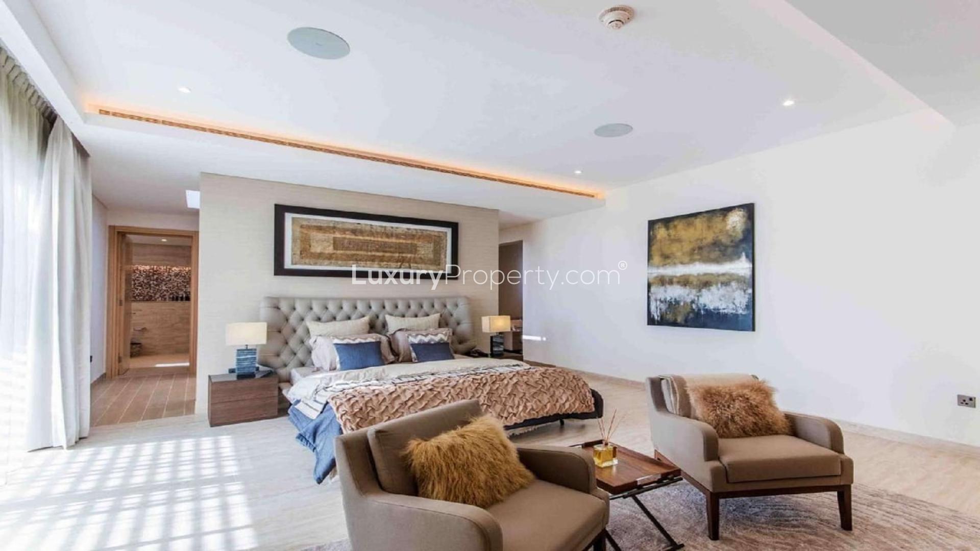 Elegant dining room in five-bedroom Sobha Hartland villa, featuring modern decor and garden view