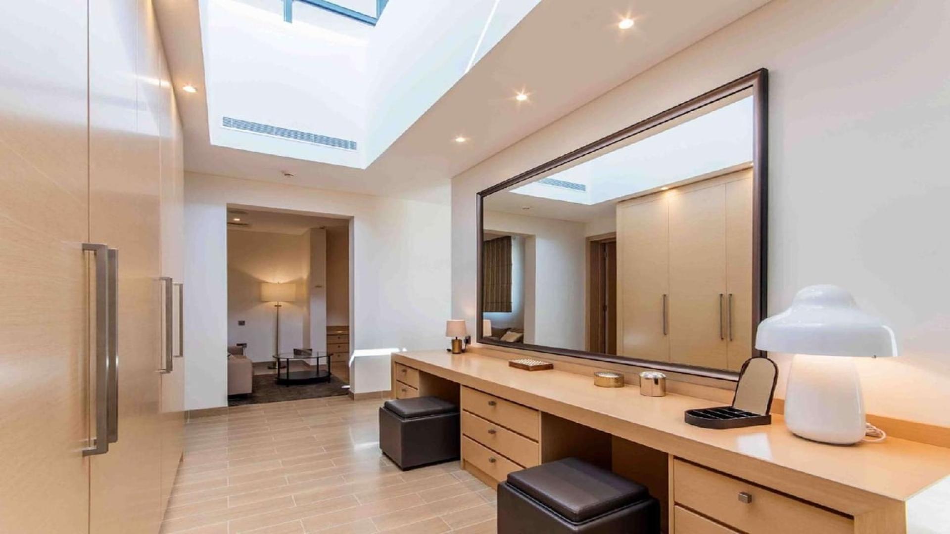 "Stunning 5-bedroom forest villa for sale in Sobha Hartland, Mohammed Bin Rashid City.",Luxurious dressing area in Sobha Hartland villa, featuring elegant vanity and ample natural light