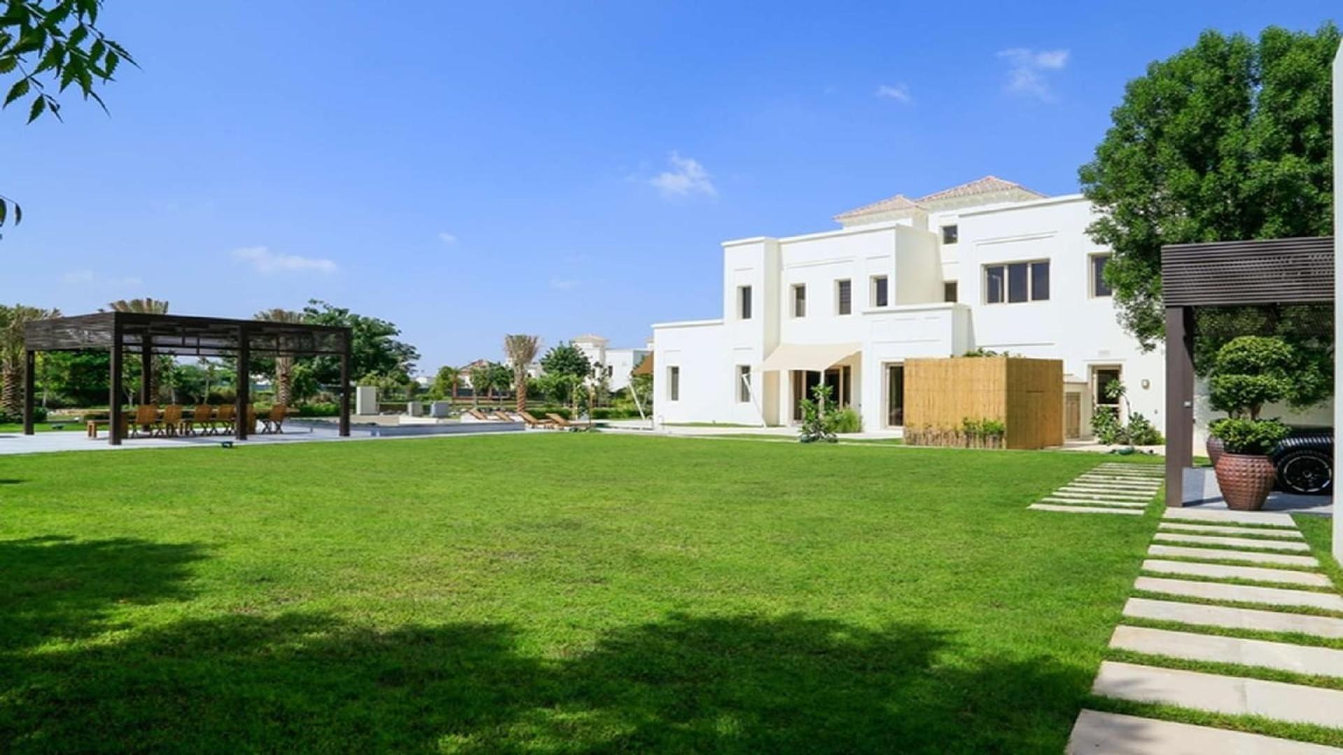 Luxurious villa poolside view with sun loungers, Ajman Uptown, for sale