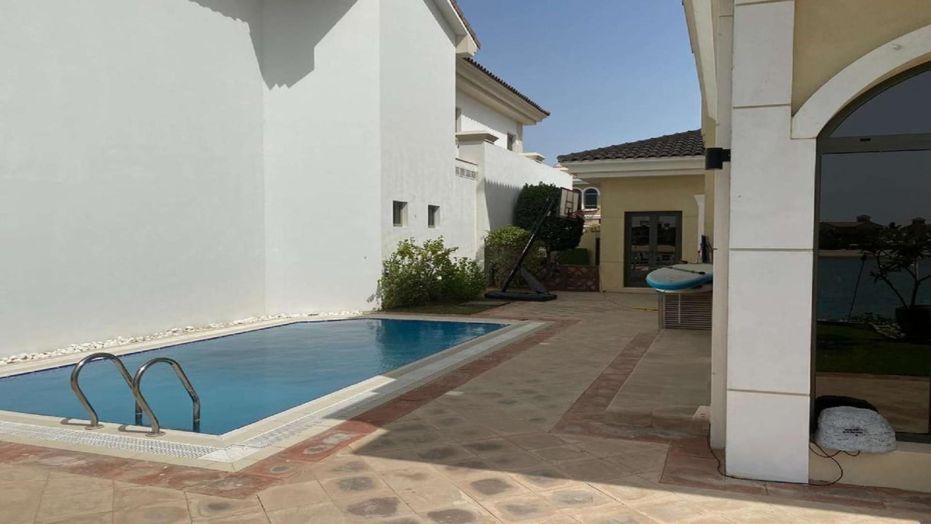 Elegant 5-bedroom villa exterior with garden on Palm Jumeirah, Garden Homes community