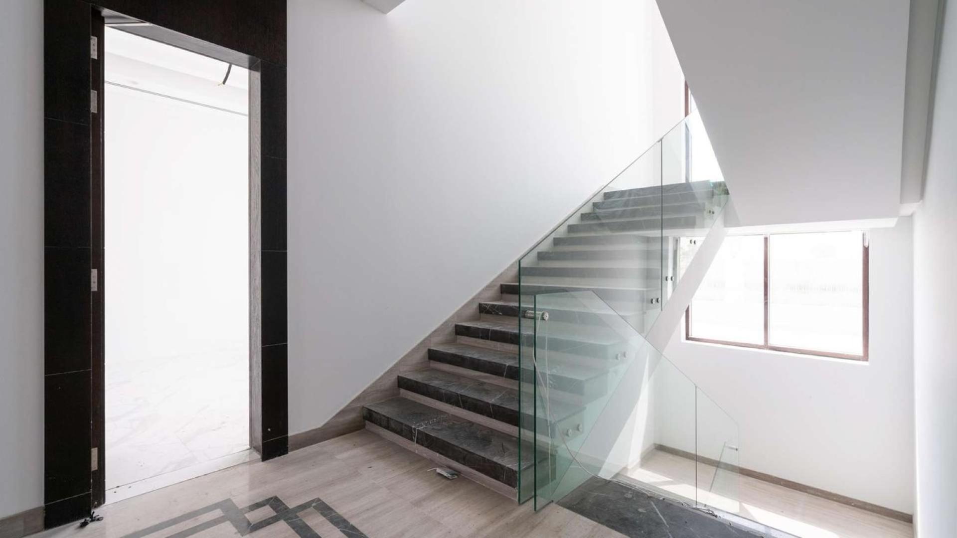 Modern living room in exclusive Dubai Hills Estate villa for sale, featuring elegant decor