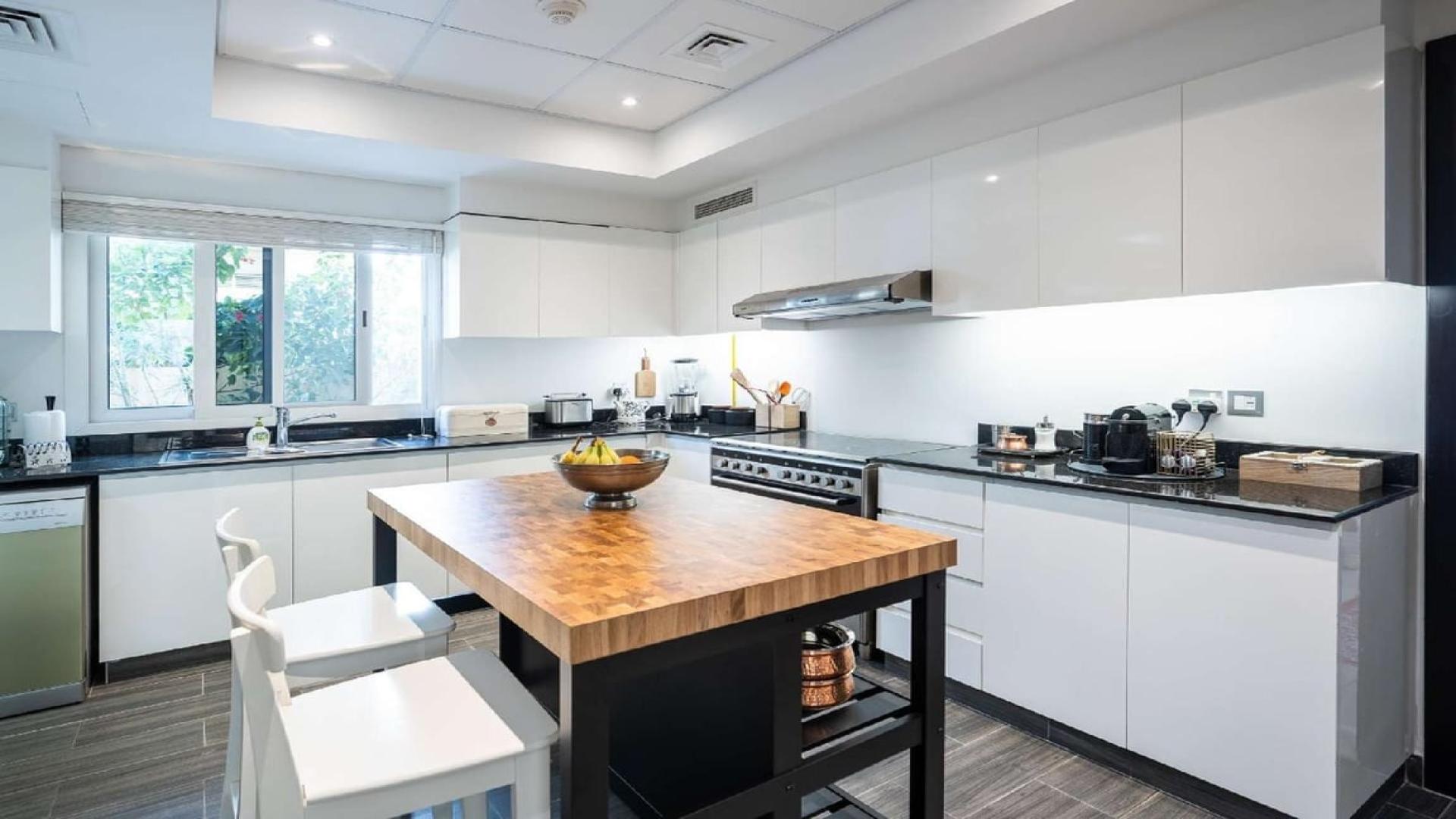 Elegant villa entrance with lush greenery at Jumeirah Golf Estates, Royal Golf Villas