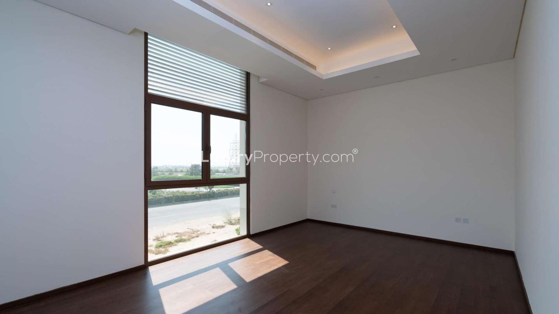 Spacious villa interior with modern finishes, large windows, and garden view in Meydan