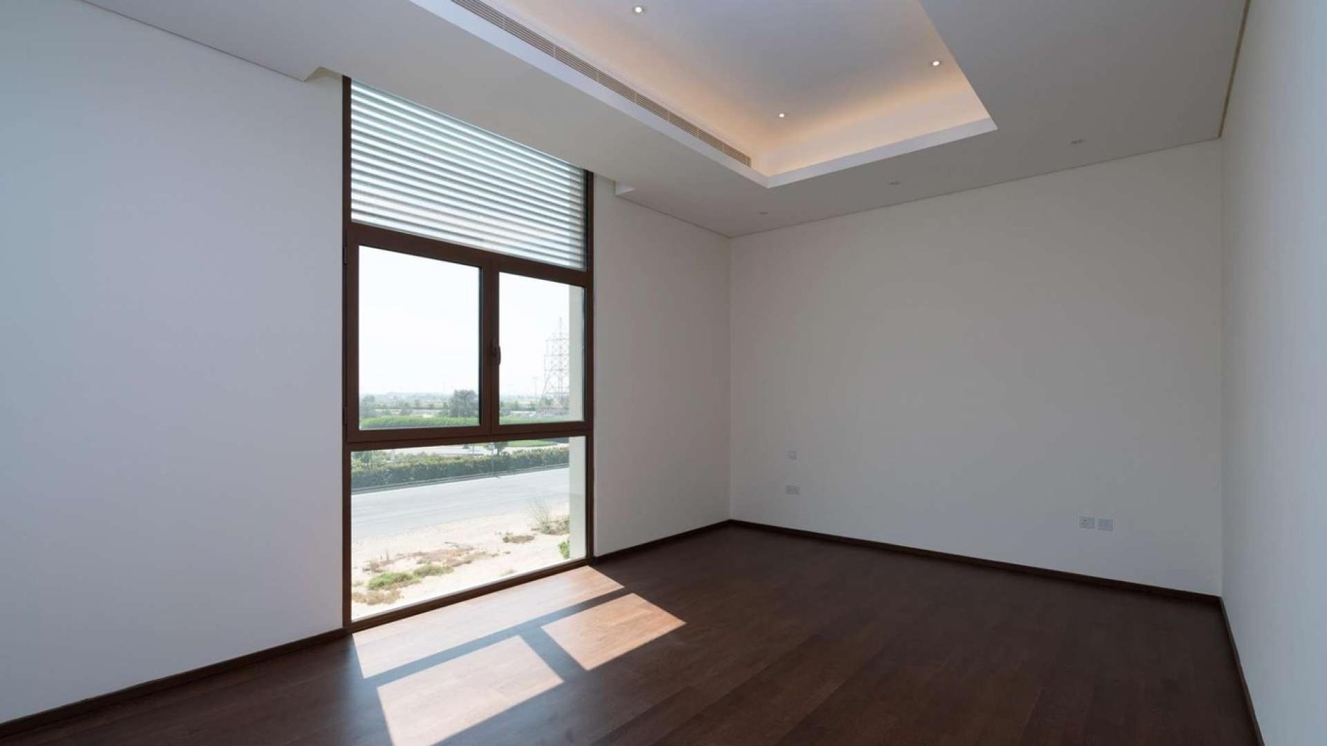 Spacious villa interior with modern finishes, large windows, and garden view in Meydan