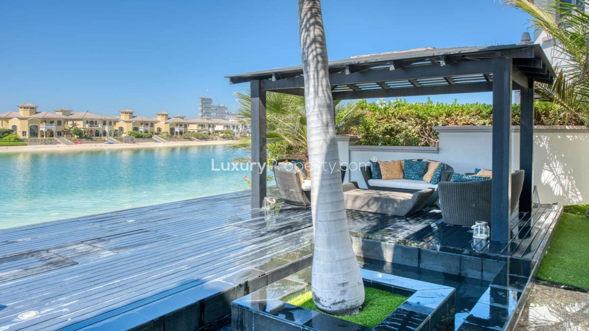 Luxurious living room in Palm Jumeirah villa with Atlantis view, elegant decor, bright ambiance