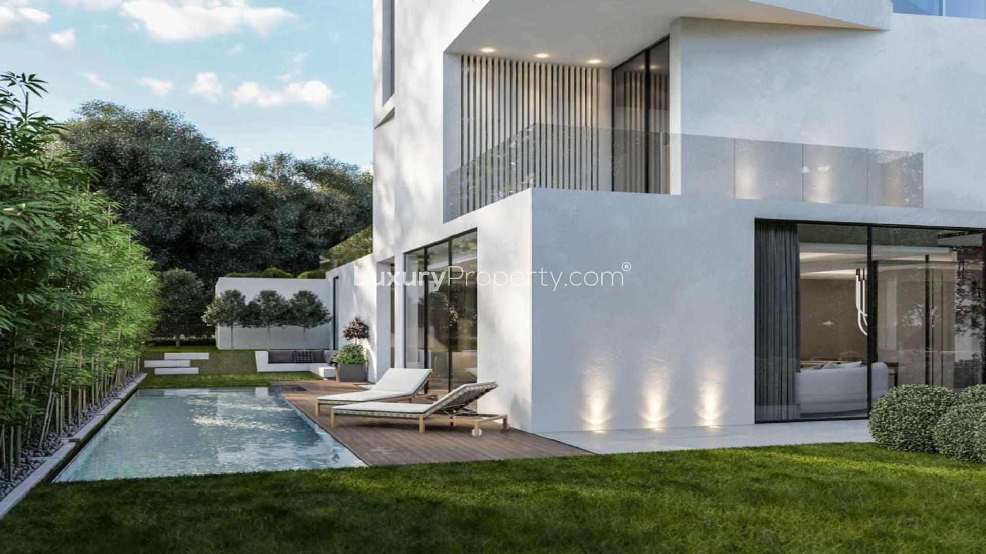 Luxurious living room in Chorisia Villas, Al Barari with modern decor and garden view