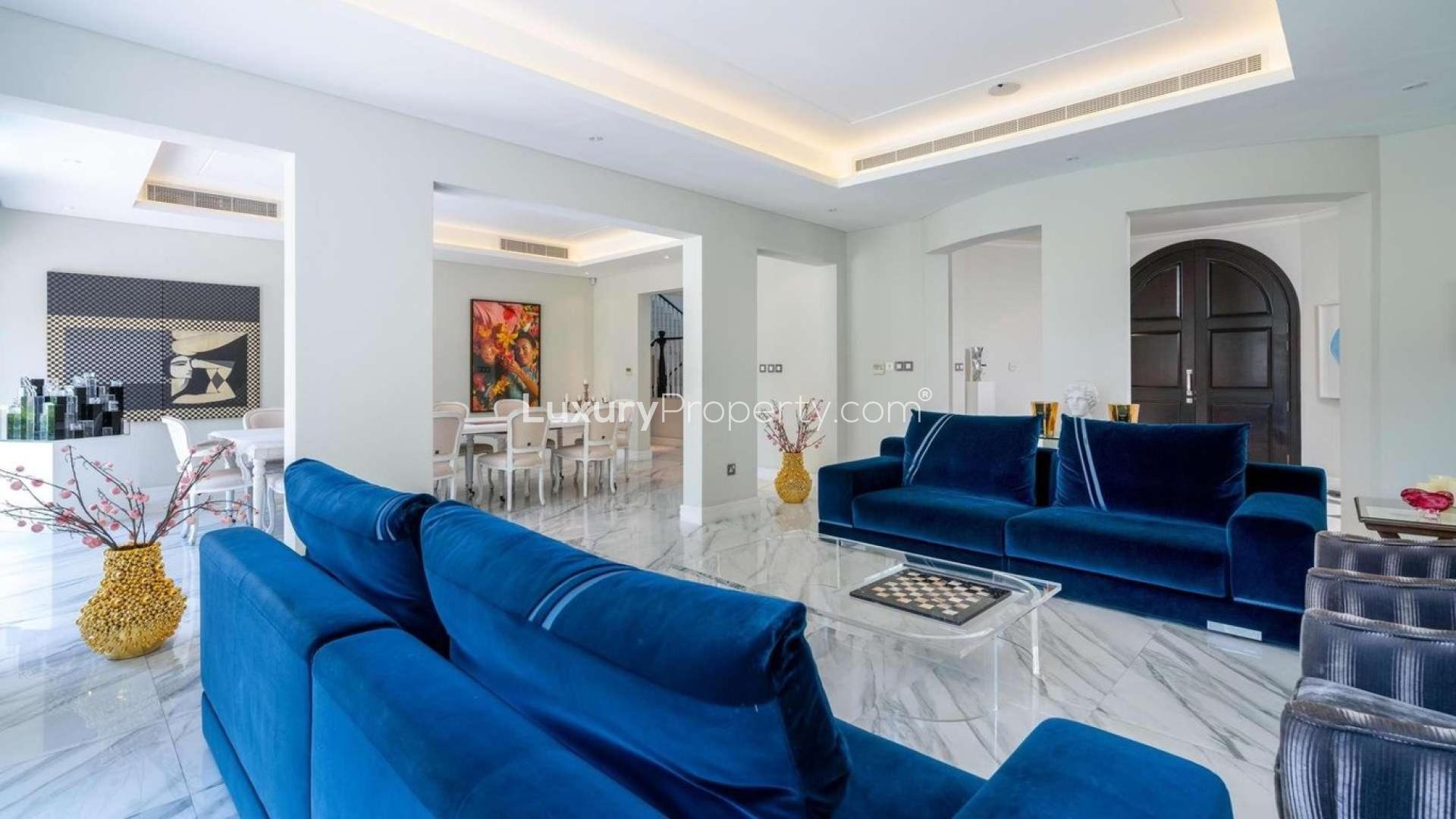 Luxurious living room in 5-bedroom villa, Olive Point, Jumeirah Golf Estates, elegant blue sofas