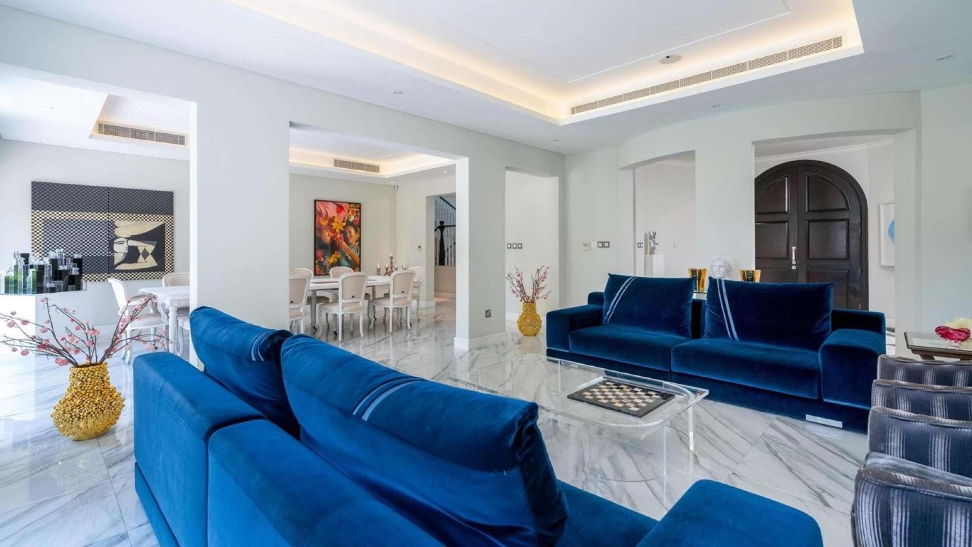Luxurious living room in 5-bedroom villa, Olive Point, Jumeirah Golf Estates, elegant blue sofas
