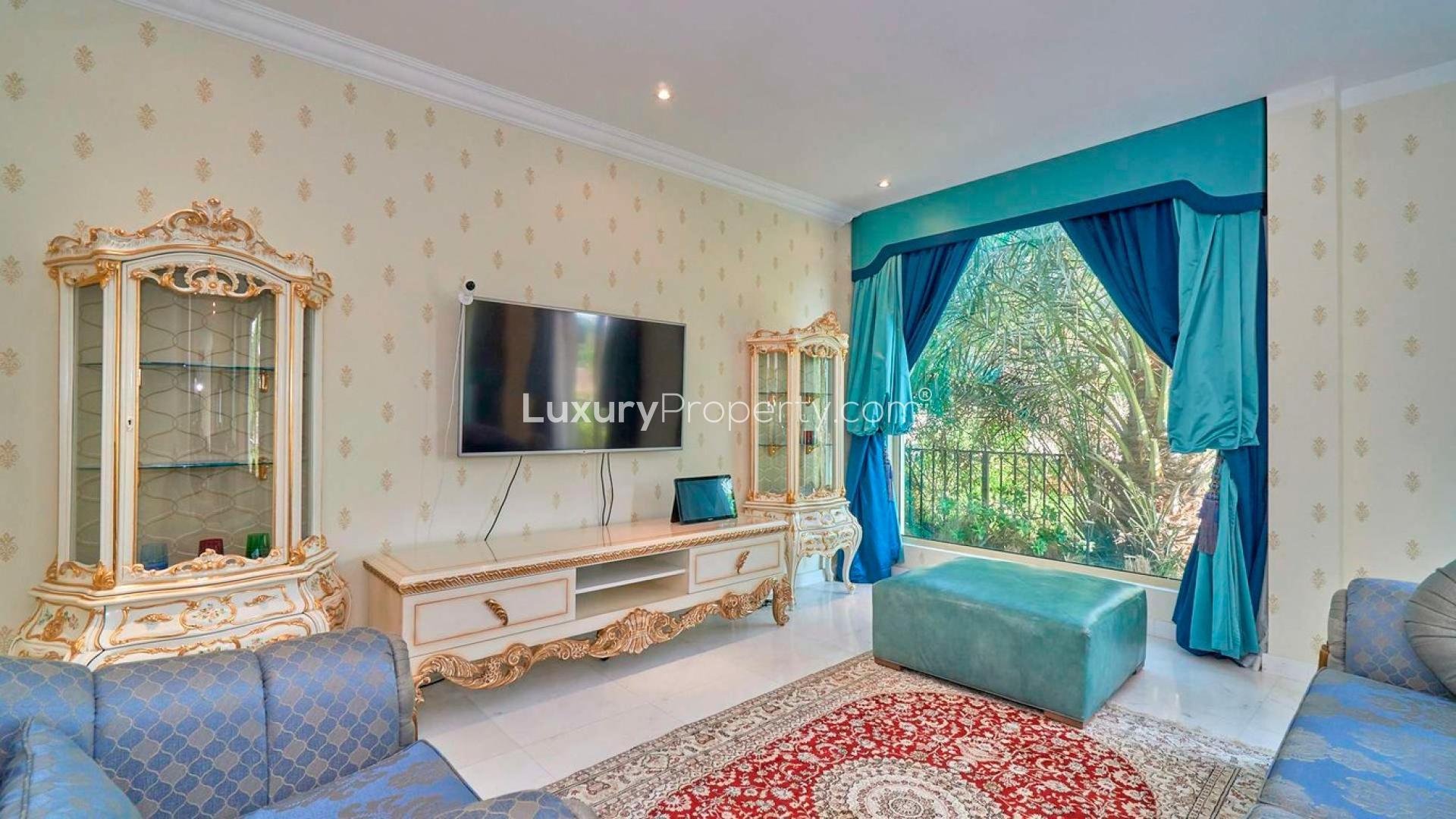 "Beautiful villa exterior with lush garden in Jumeirah Islands, European Clusters, Dubai.",Luxurious living room in five-bedroom villa, Jumeirah Islands, European Clusters, elegant decor
