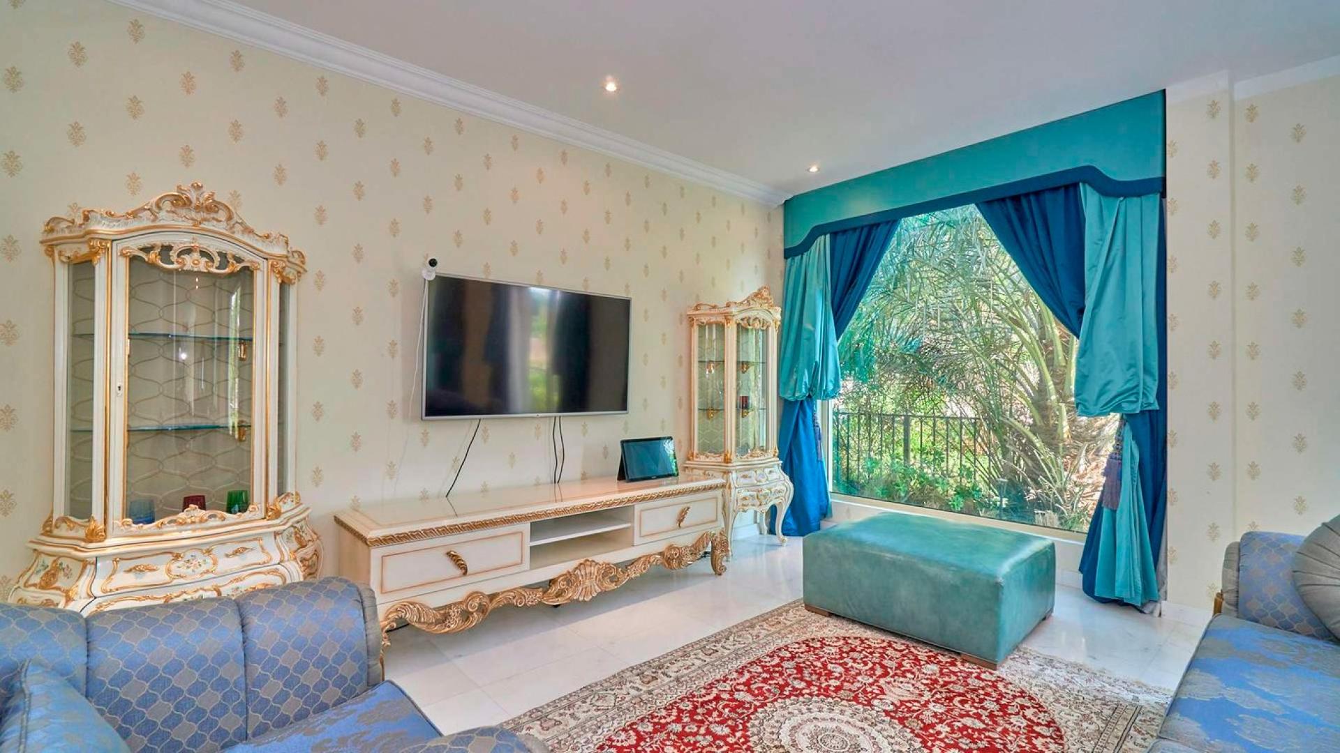 "Beautiful villa exterior with lush garden in Jumeirah Islands, European Clusters, Dubai.",Luxurious living room in five-bedroom villa, Jumeirah Islands, European Clusters, elegant decor