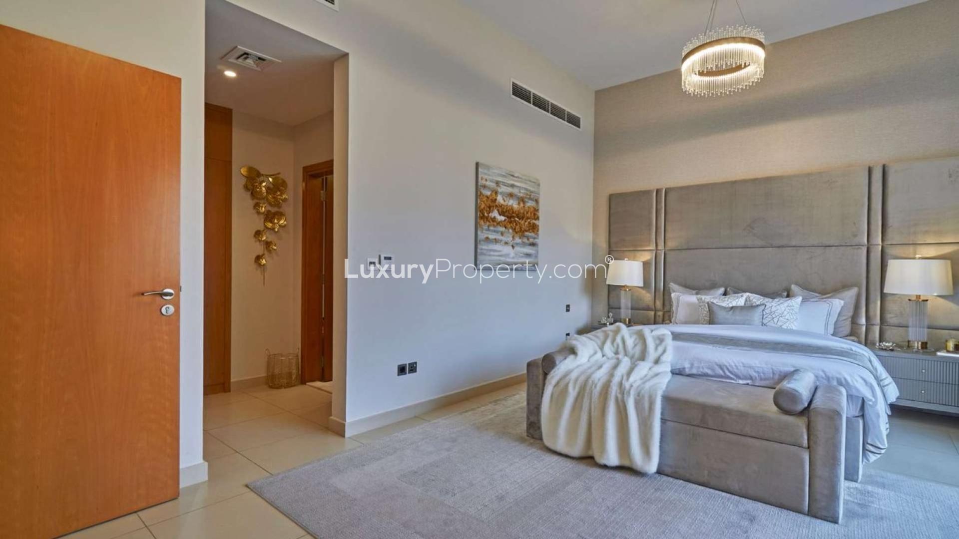 Luxurious living room in Nad Al Sheba 1 villa with elegant decor and large windows