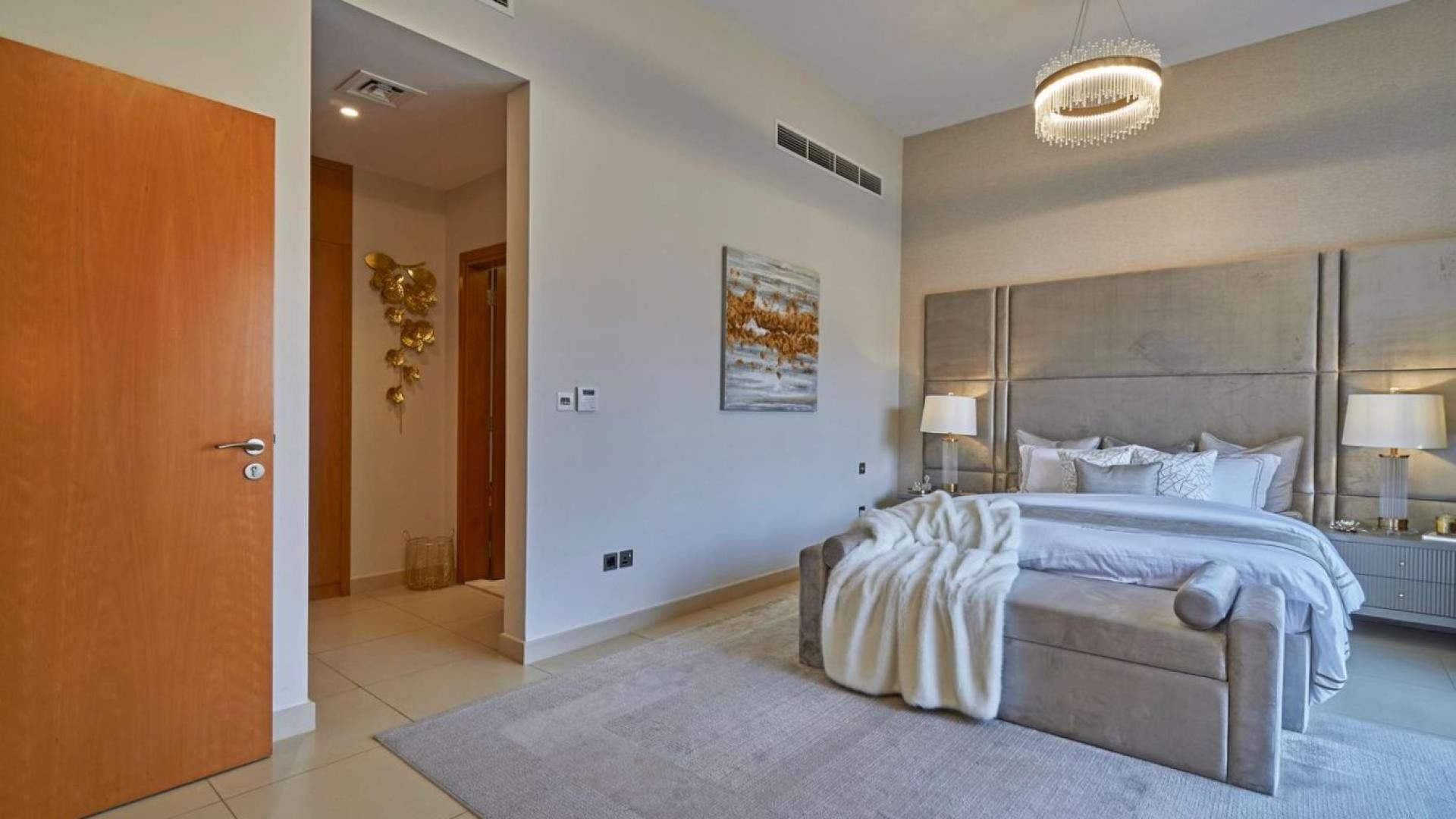 Luxurious living room in Nad Al Sheba 1 villa with elegant decor and large windows