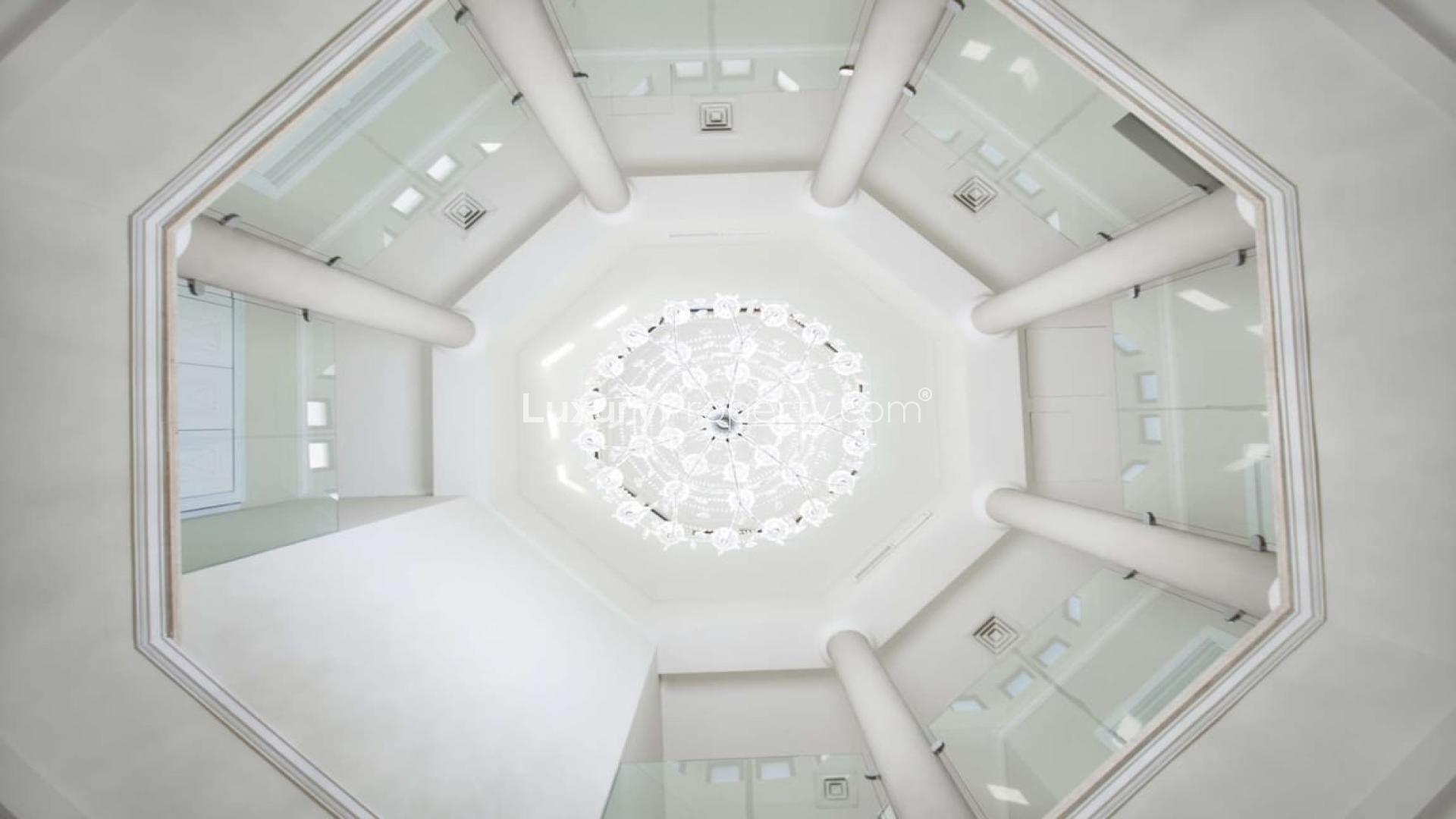 Elegant chandelier in modernized central rotunda of Palm Jumeirah villa, Signature Villas