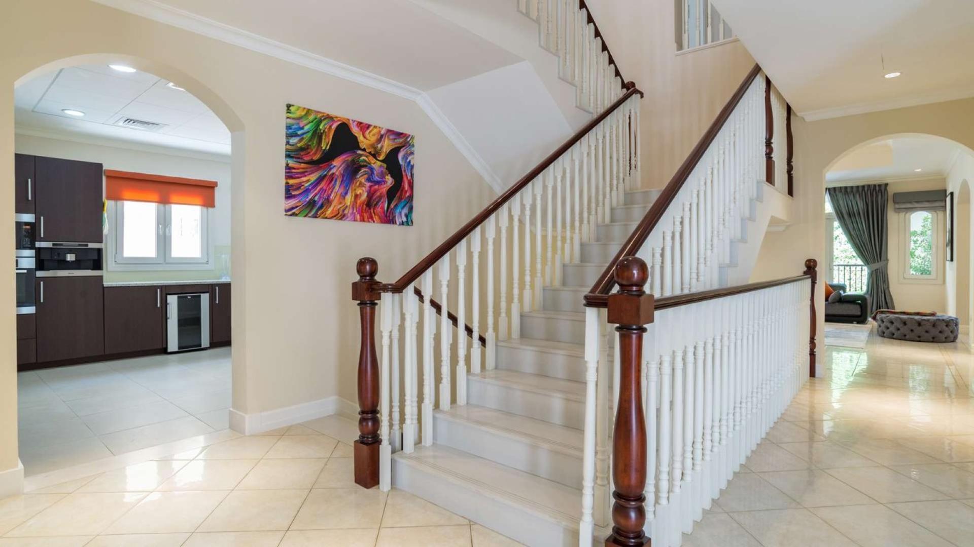 Living room in spacious Jumeirah Golf Estates villa with modern decor and large windows